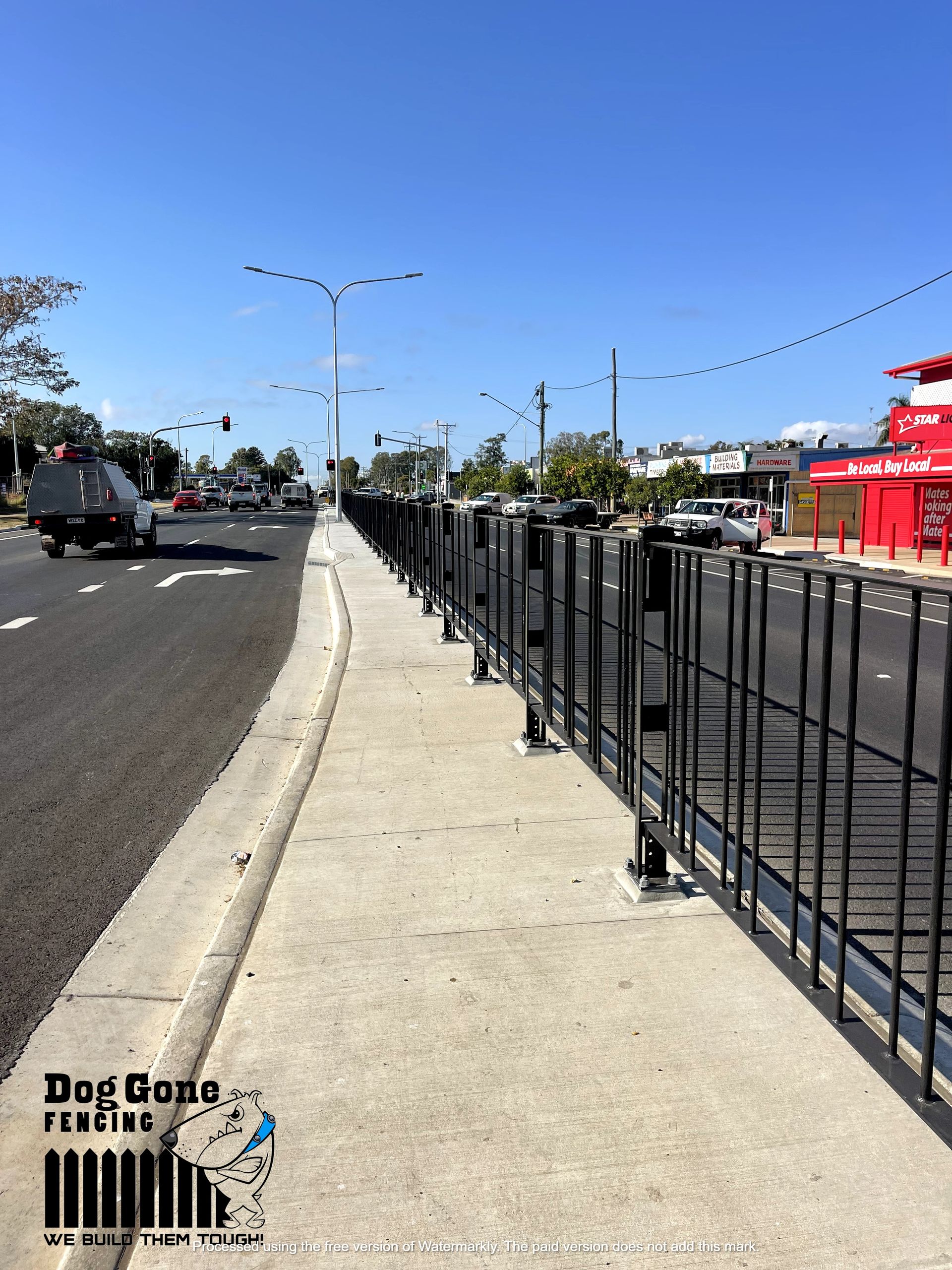 A Sidewalk With A Fence Along The Side Of The Road— Dog Gone Fencing in Paget, QLD
