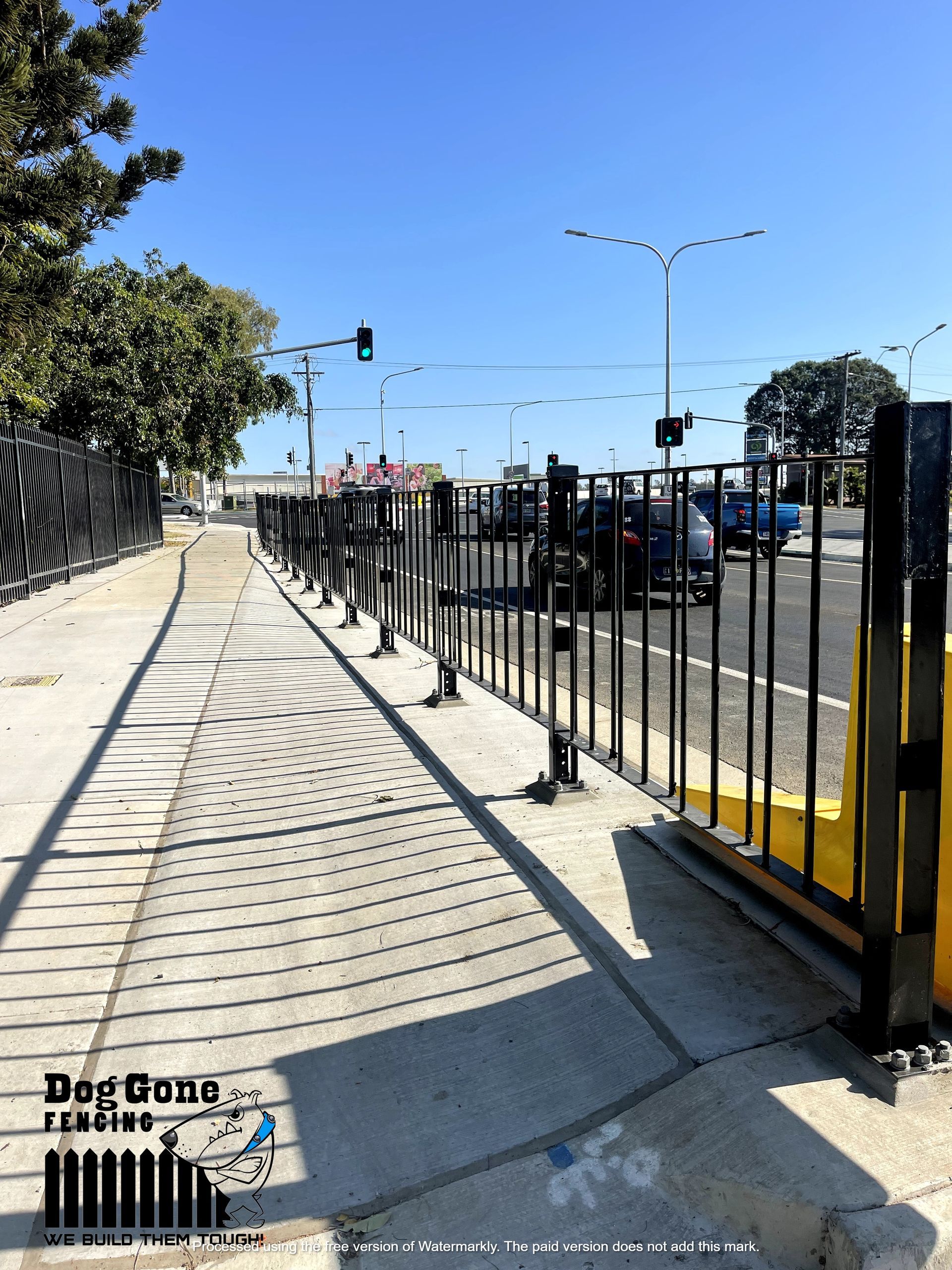 A Sidewalk With A Fence And A Sign That Says Dog Gang — Dog Gone Fencing in Paget, QLD