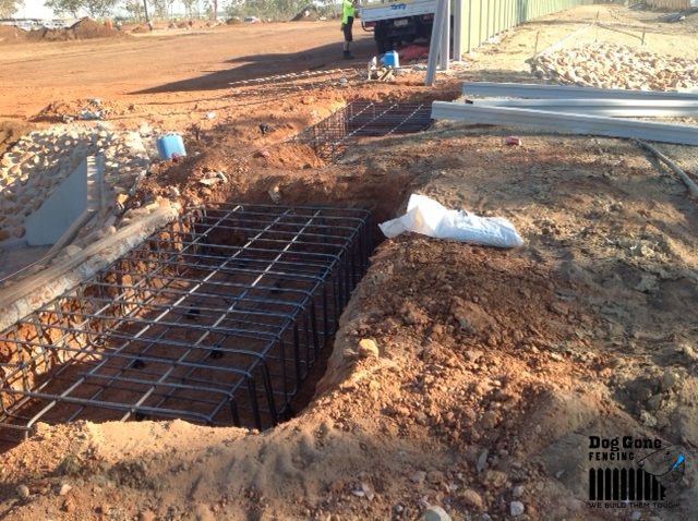 A Large Hole In The Ground With A Metal Structure In It — Dog Gone Fencing in Paget, QLD