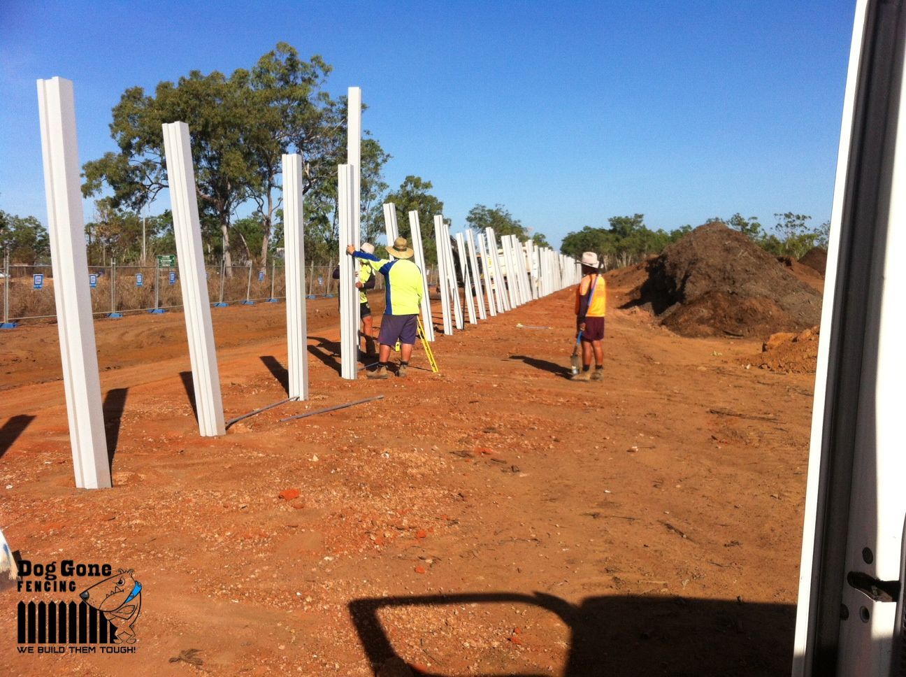 A Group of People are Standing next to a white fence - Fencing in Mackay, QLD