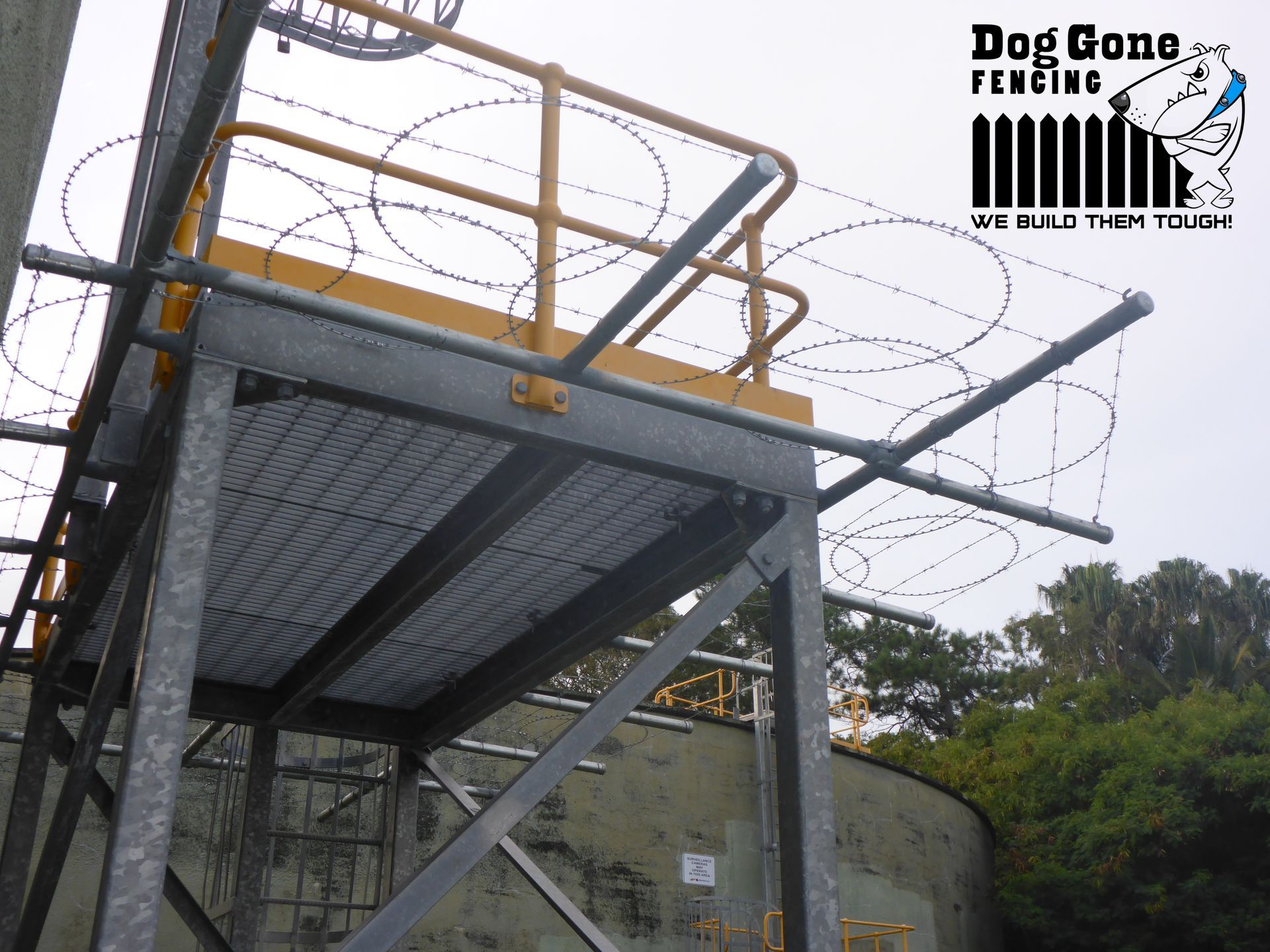 A Fence With Barbed Wire  — Dog Gone Fencing in Paget, QLD