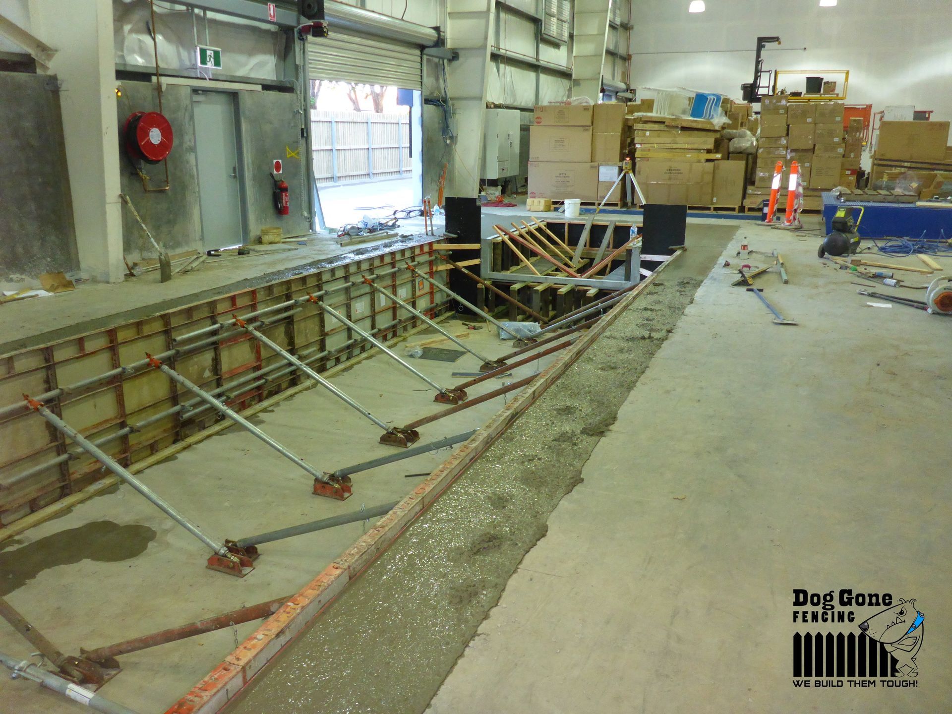 A Warehouse With Boxes On The Floor And A Sign That Says Dog Gone Fishing - Fencing in Mackay, QLD