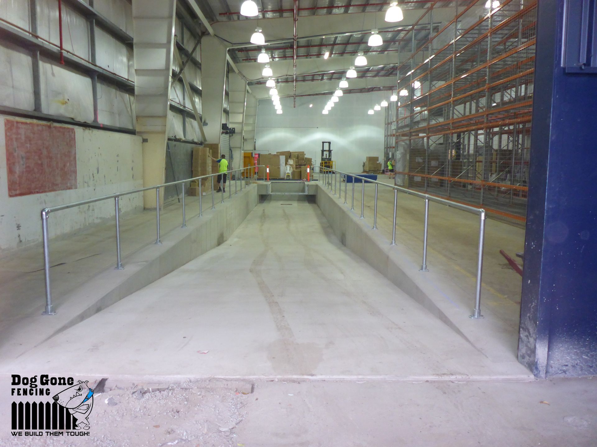 A Large Warehouse With A Ramp In The Middle Of It — Dog Gone Fencing in Paget, QLD