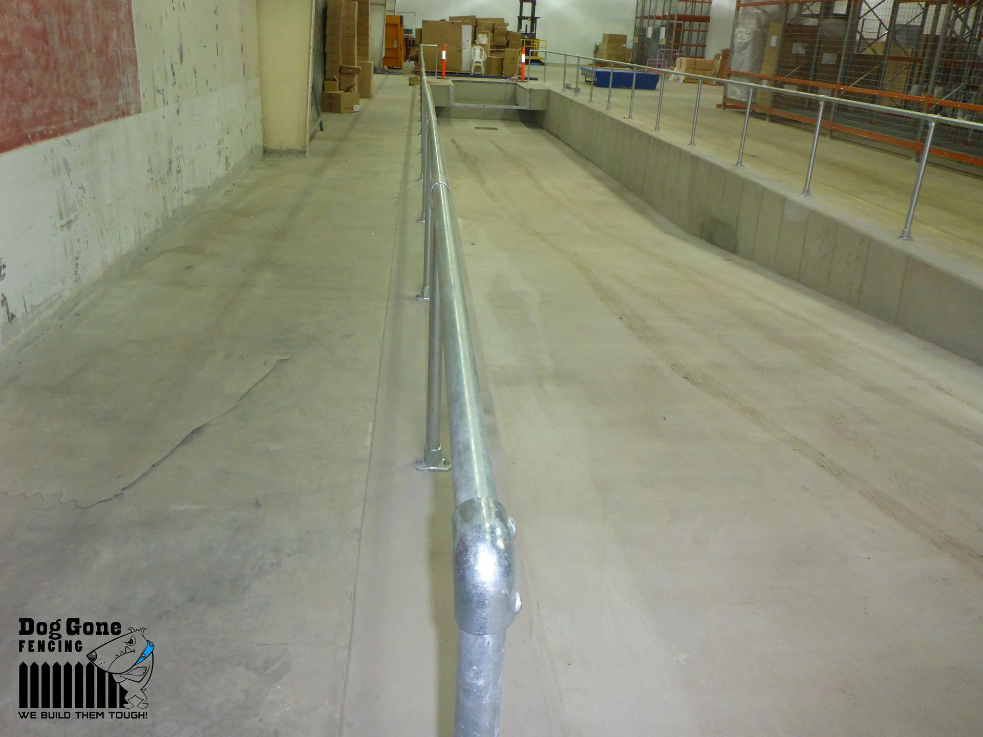 A Metal Railing Is In The Middle Of A Warehouse — Dog Gone Fencing in Paget, QLD