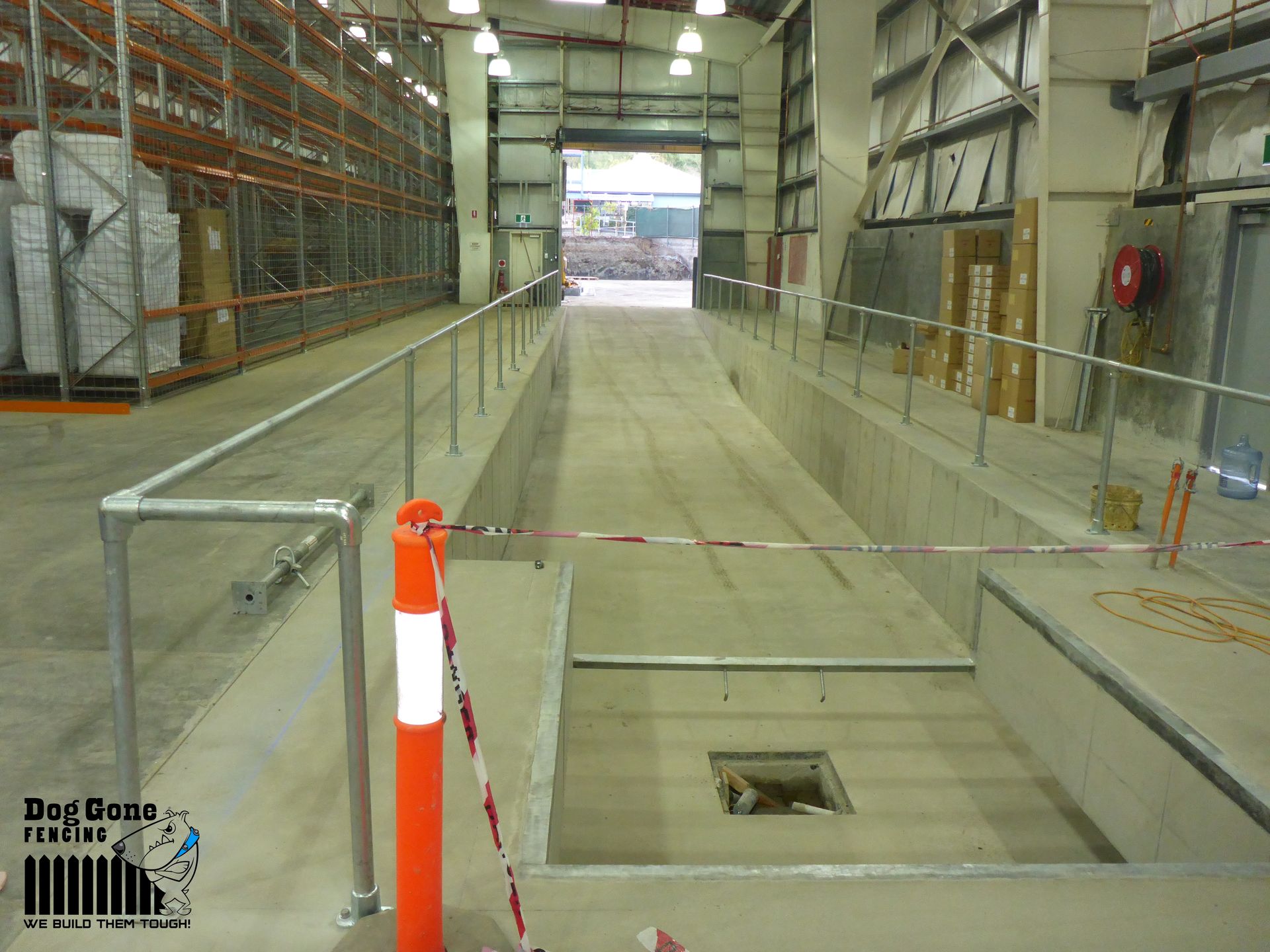 A Large Warehouse With A Staircase Leading Up To It — Dog Gone Fencing in Paget, QLD