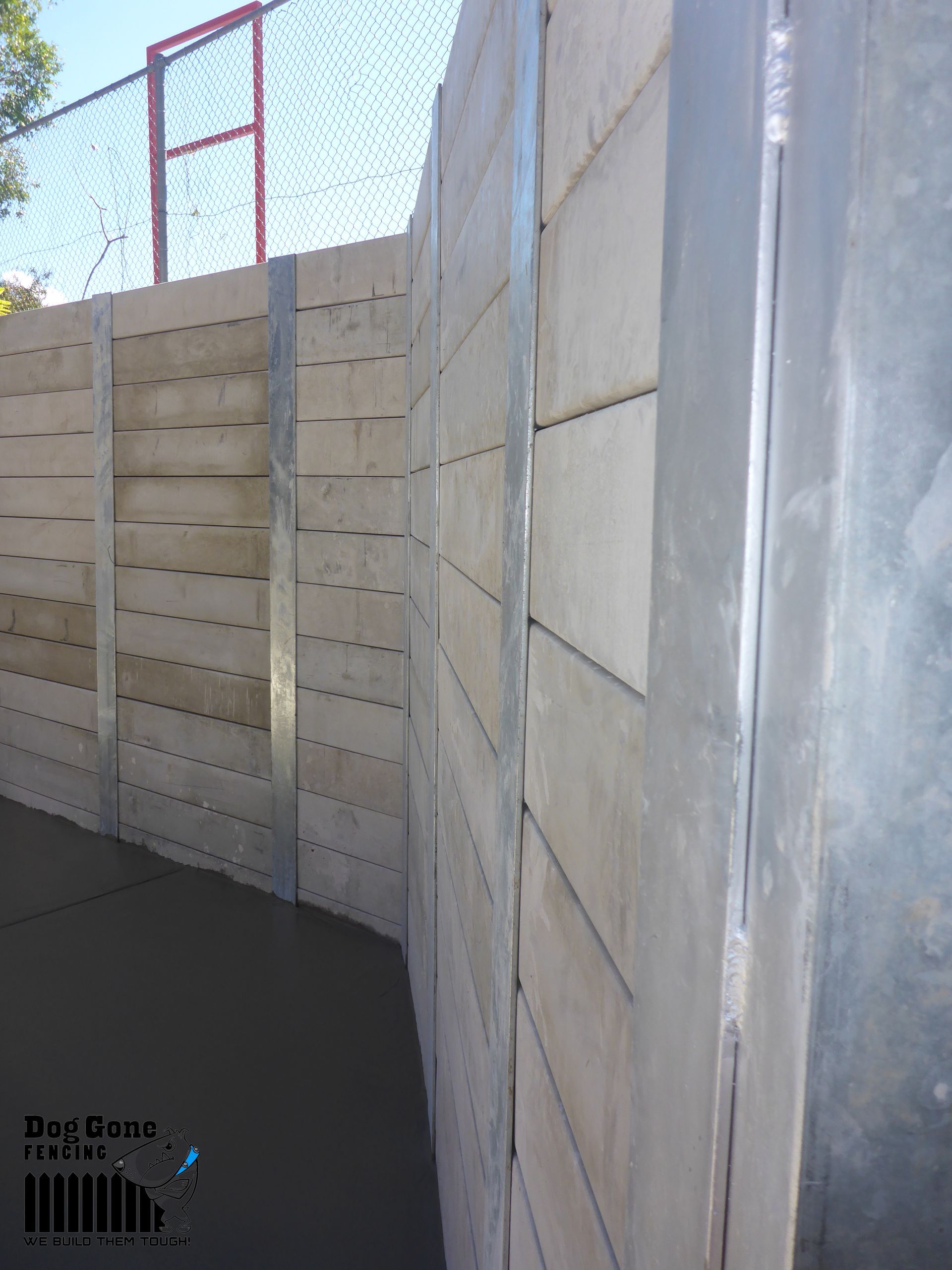 A Concrete Wall With A Metal Frame And A Fence In The Background — Dog Gone Fencing in Paget, QLD