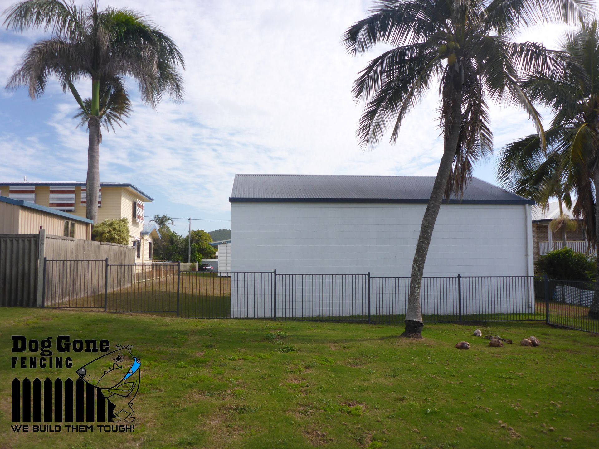 A Fenced In Yard With White House In It — Dog Gone Fencing in Paget, QLD