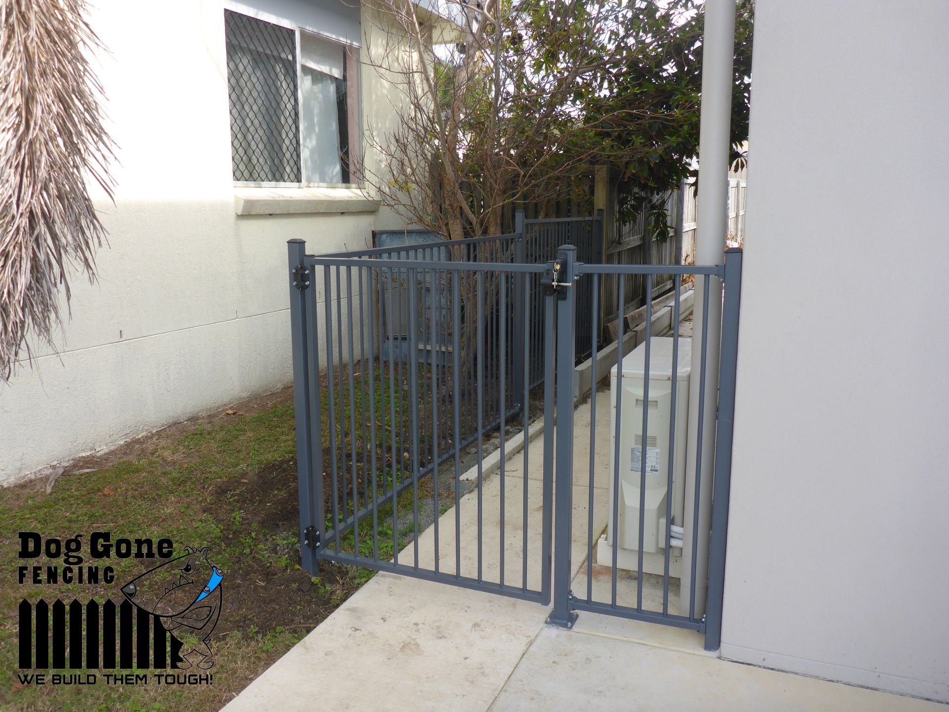 A Gray Aluminium Fence Installed On The Side Of The Building — Dog Gone Fencing in Paget, QLD