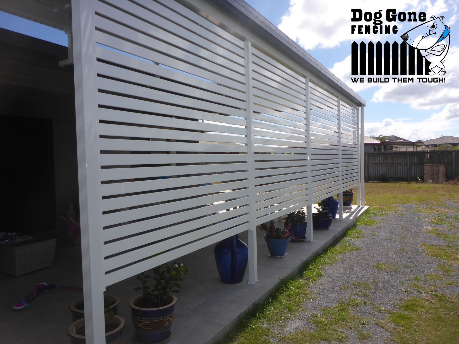 A White Fence In Front Of A Patio — Dog Gone Fencing in Paget, QLD
