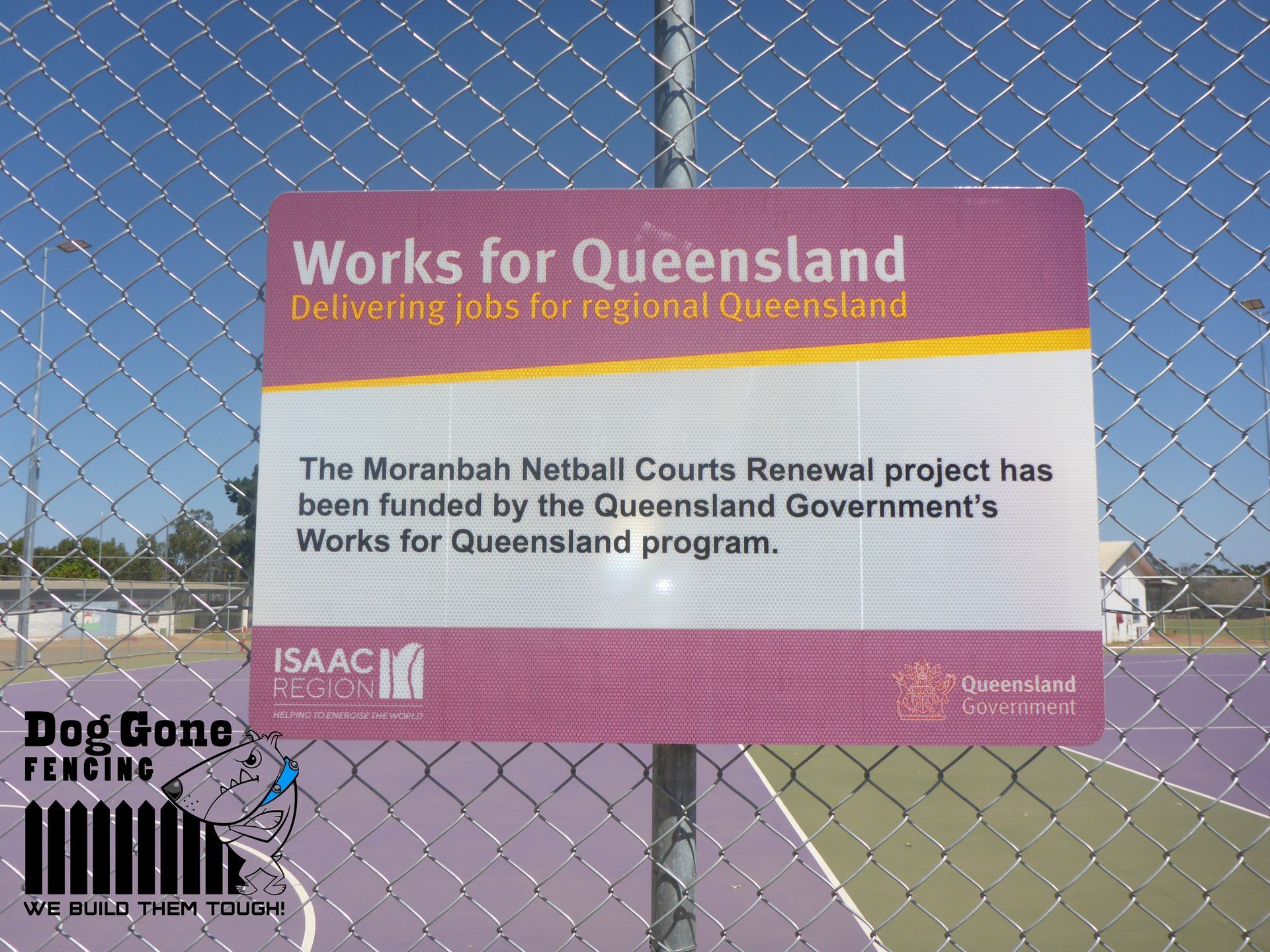 A Sign On A Chain Link Fence Says Works For Queensland — Dog Gone Fencing in Paget, QLD