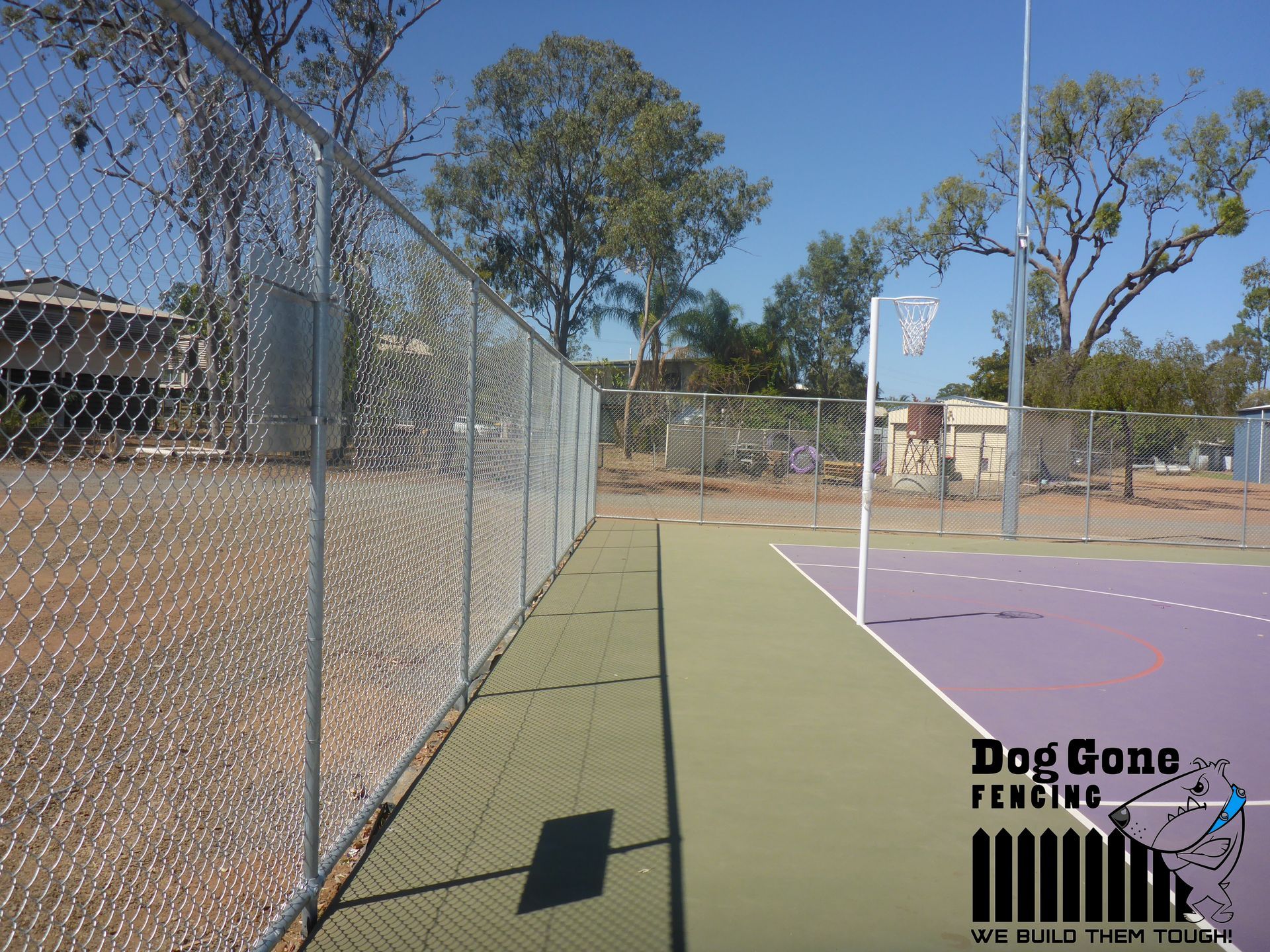 A Tennis Court With A Fence Surrounding It  — Dog Gone Fencing in Paget, QLD