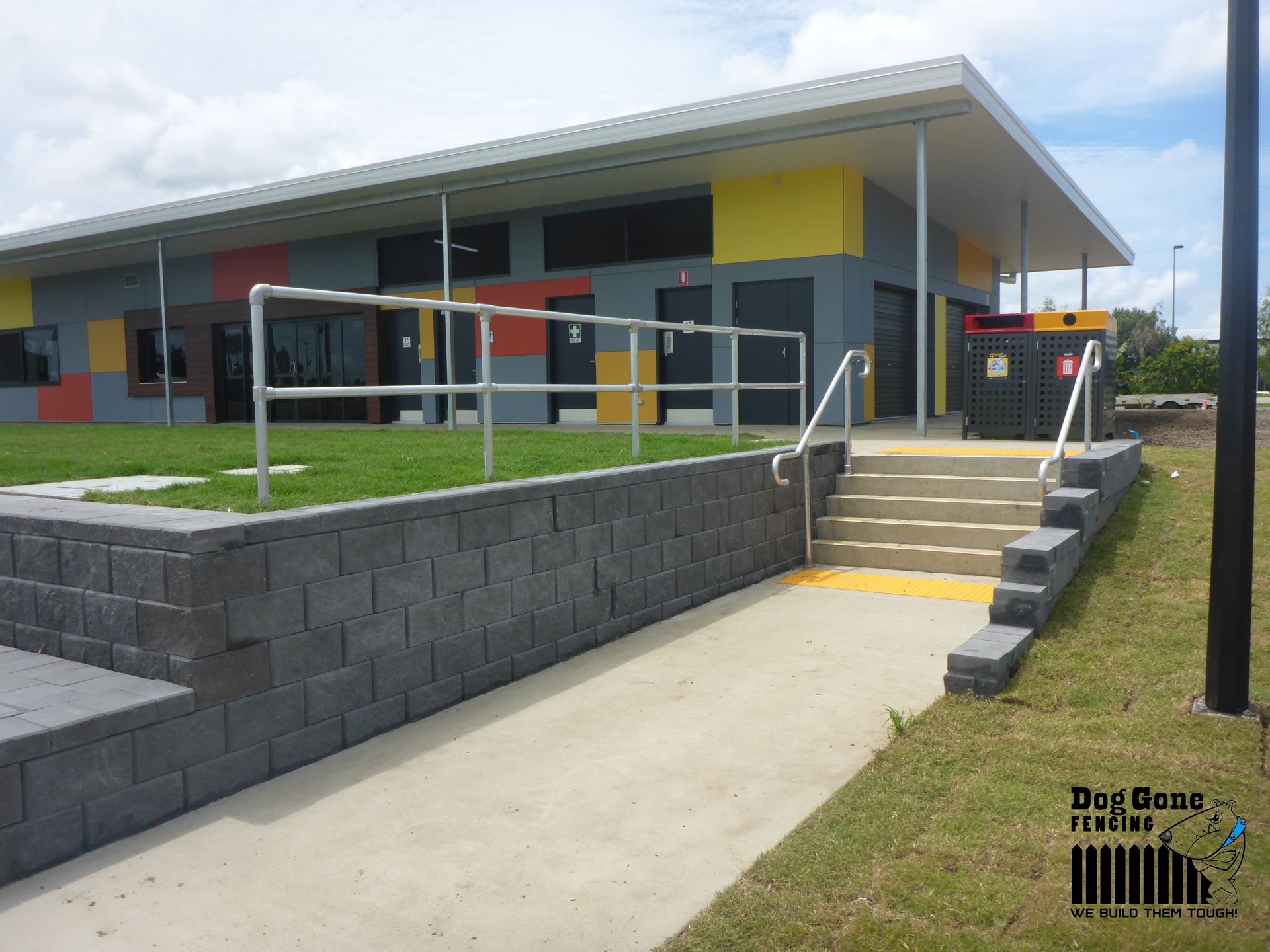 A Large Building With Stairs Leading Up To It — Dog Gone Fencing in Paget, QLD