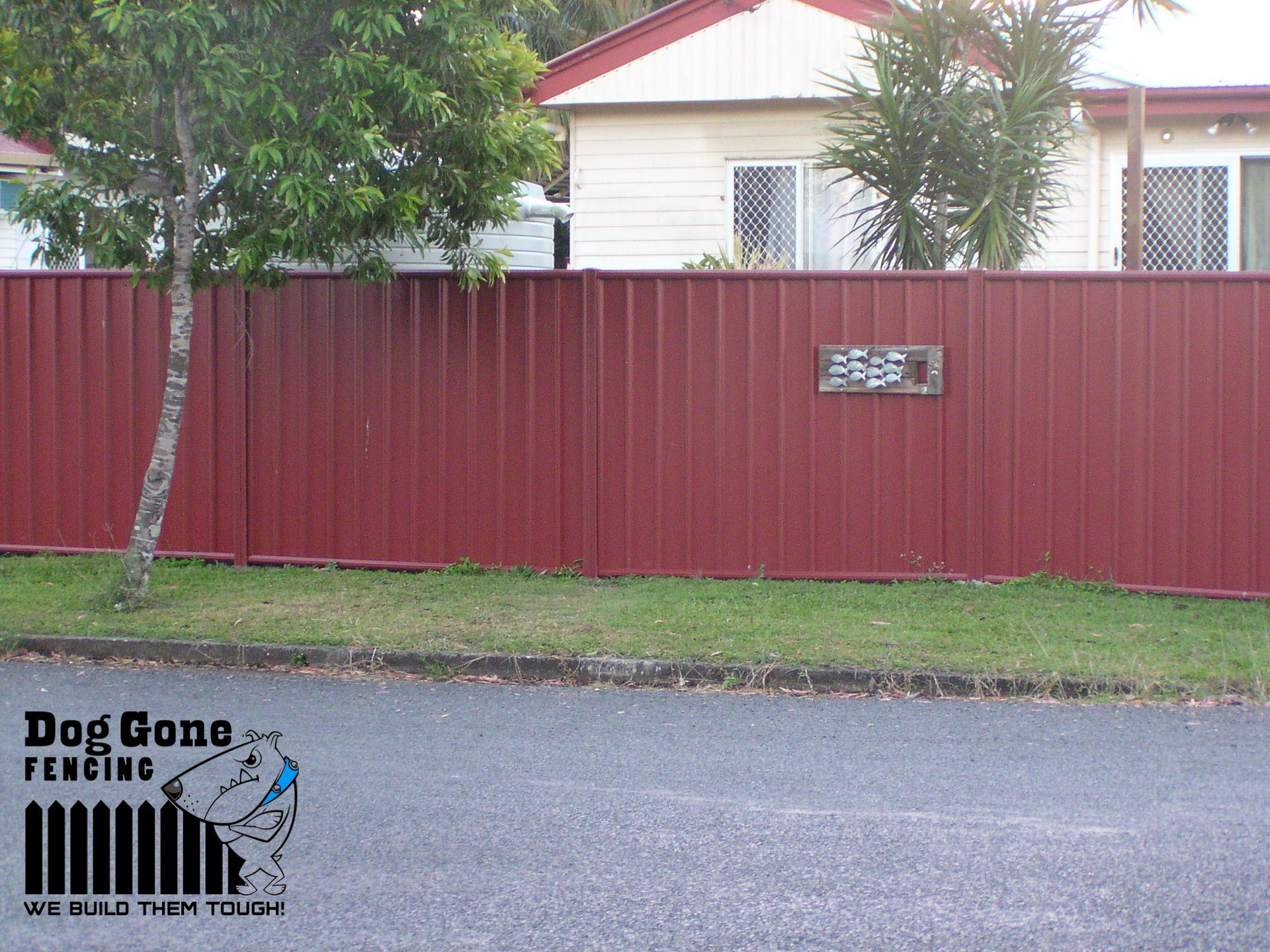 A Red Fence With A Sign That Says Stop Gone Plumbing — Dog Gone Fencing in Paget, QLD