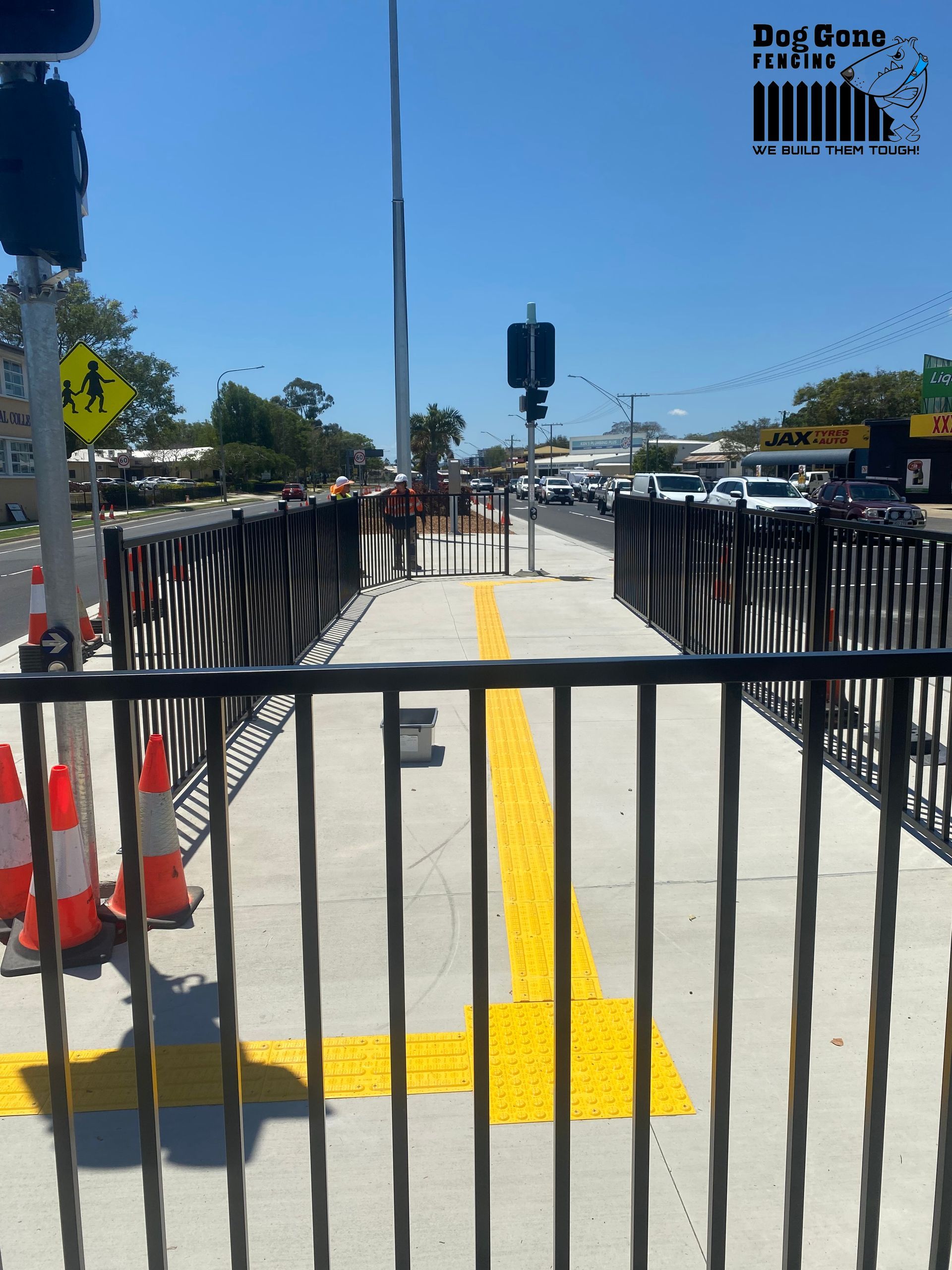 A Yellow Line Is Painted On The Sidewalk Behind A Fence - Fencing in Mackay, QLD