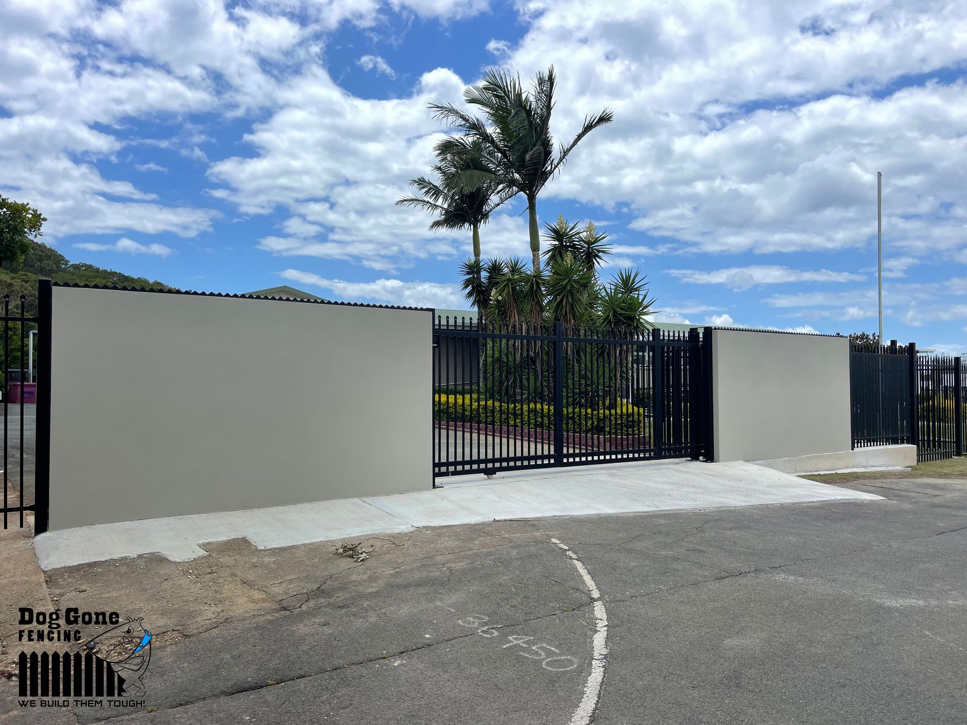 A Fence With A Palm Tree In The Background And A Basketball Court In The Foreground  — Dog Gone Fencing in Paget, QLD