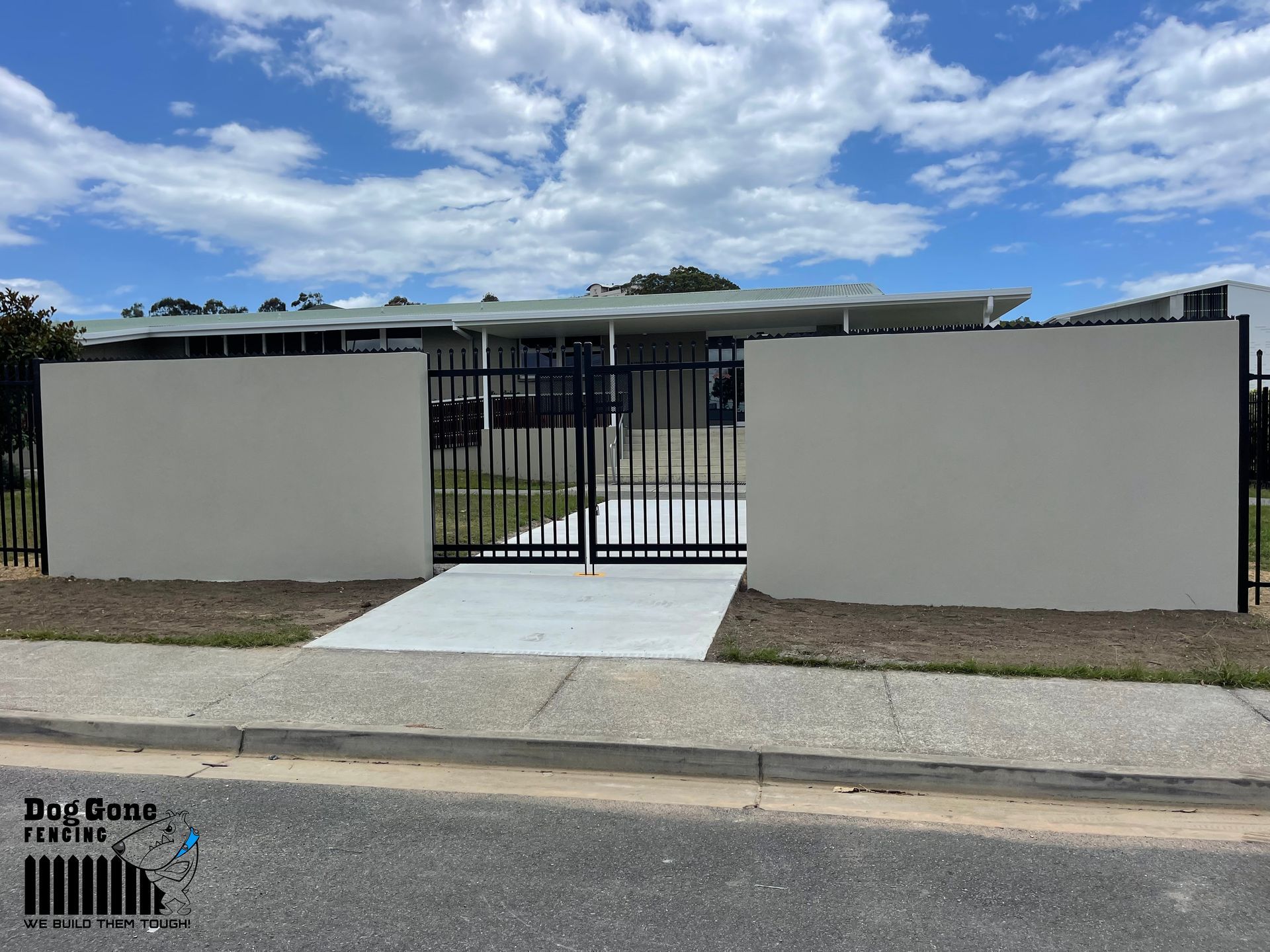 A House With A Fence And A Driveway In Front Of It — Dog Gone Fencing in Paget, QLD