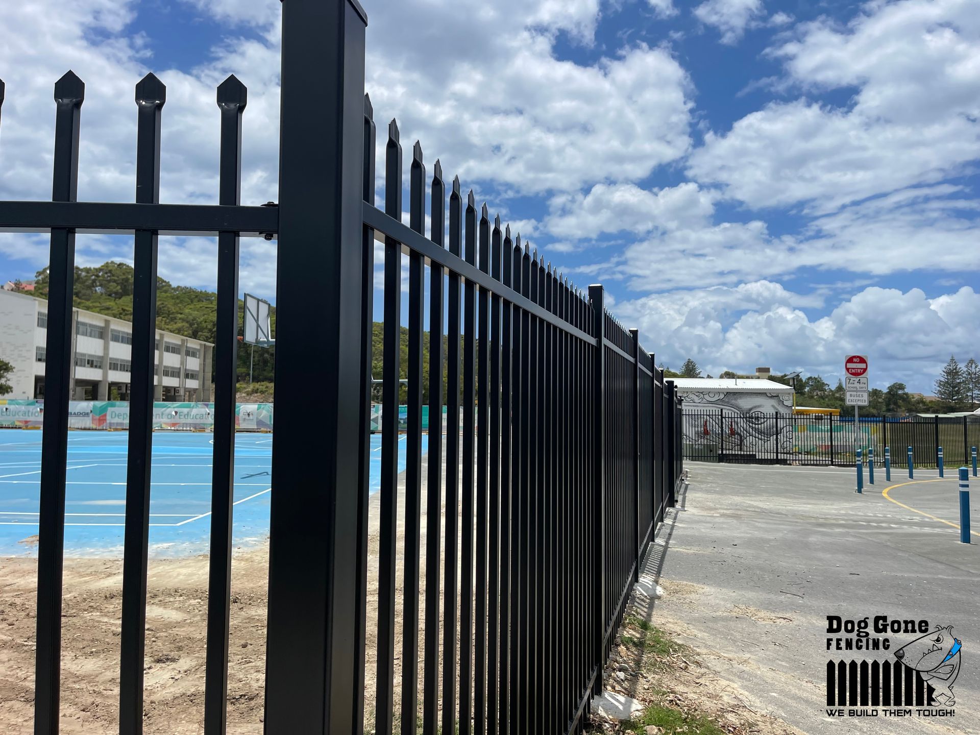 A Black Metal Fence Is Surrounding A Basketball Court — Dog Gone Fencing in Paget, QLD