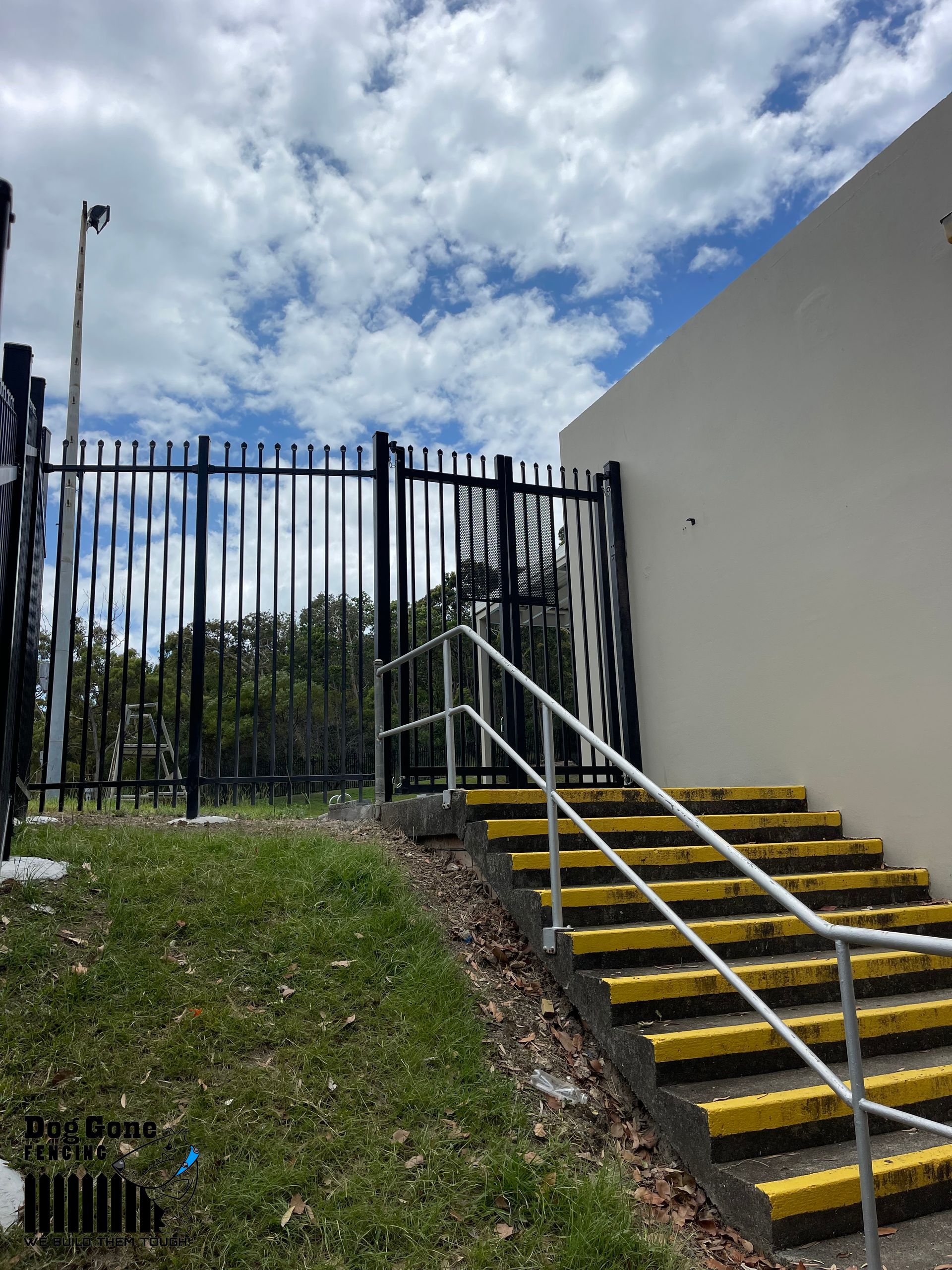 A Set Of Stairs Leading Up To A Fence With A Railing — Dog Gone Fencing in Paget, QLD