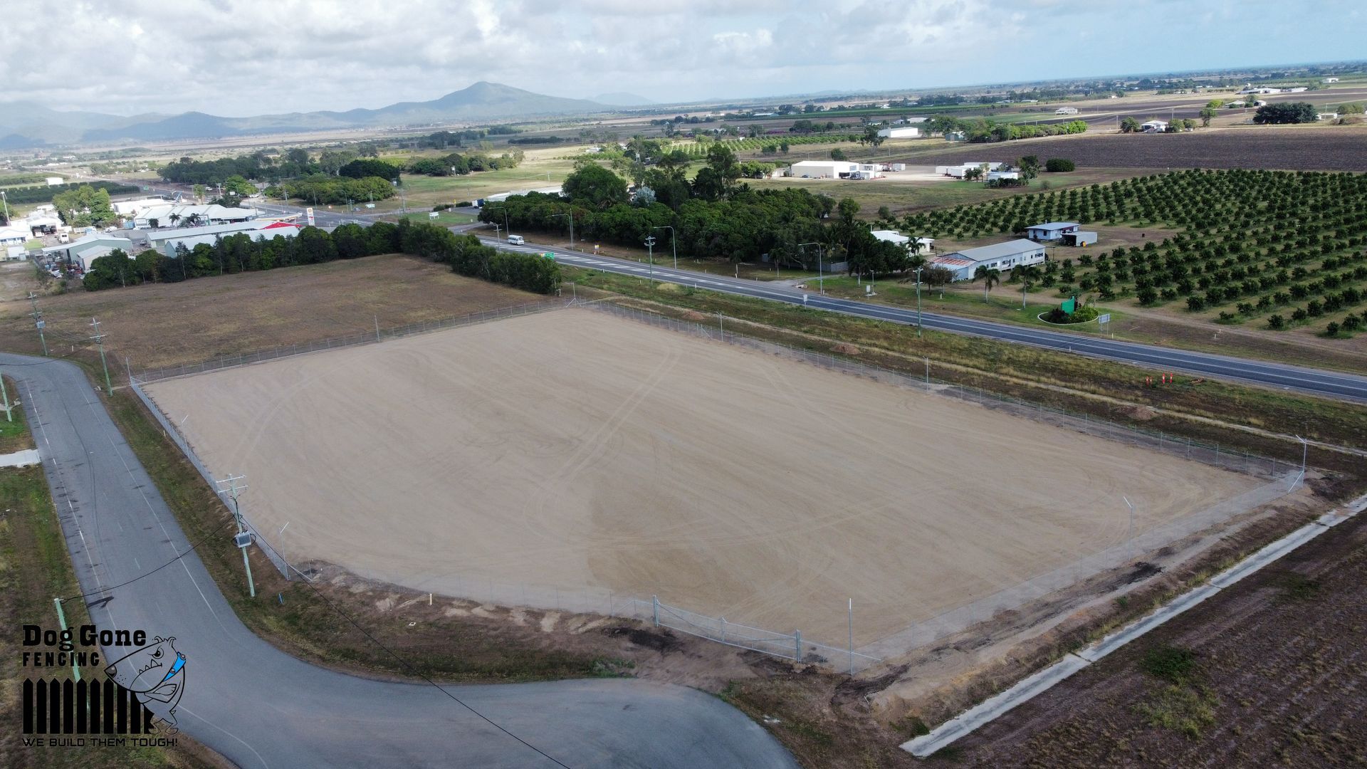 An Aerial View Of A Large Dirt Field Next To A Road — Dog Gone Fencing in Paget, QLD