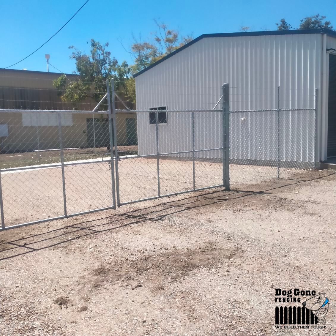 A Fenced In Area With A Building In The Background — Dog Gone Fencing in Paget, QLD