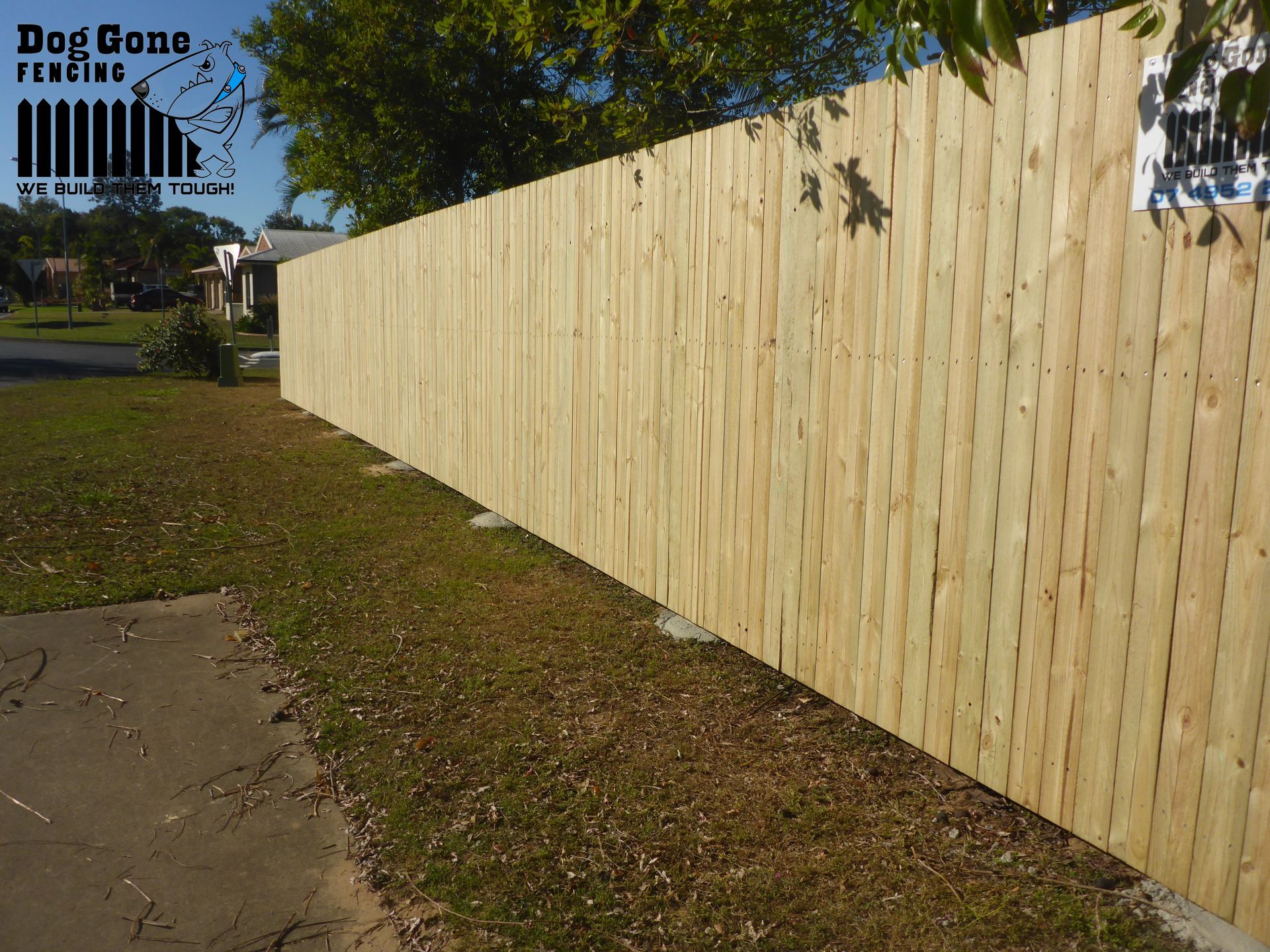 A Wooden Fence In A Backyard — Dog Gone Fencing in Paget, QLD