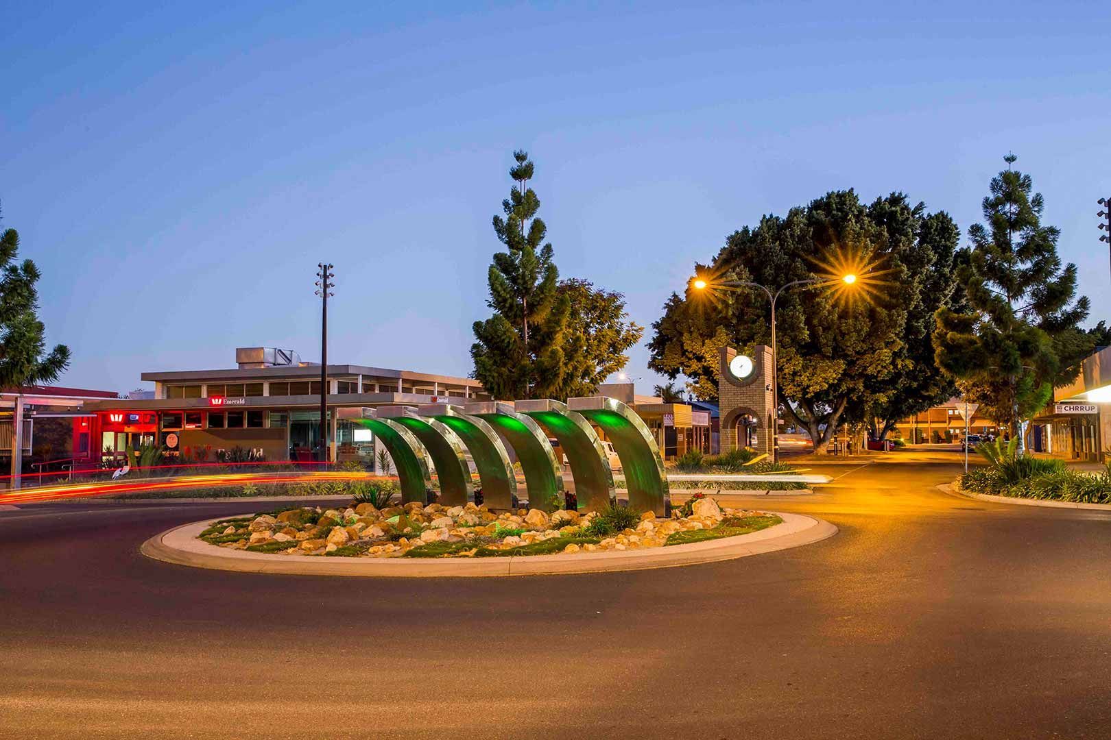 A Roundabout With A Green Sculpture In The Middle Of It — Dog Gone Fencing in Emerald, QLD