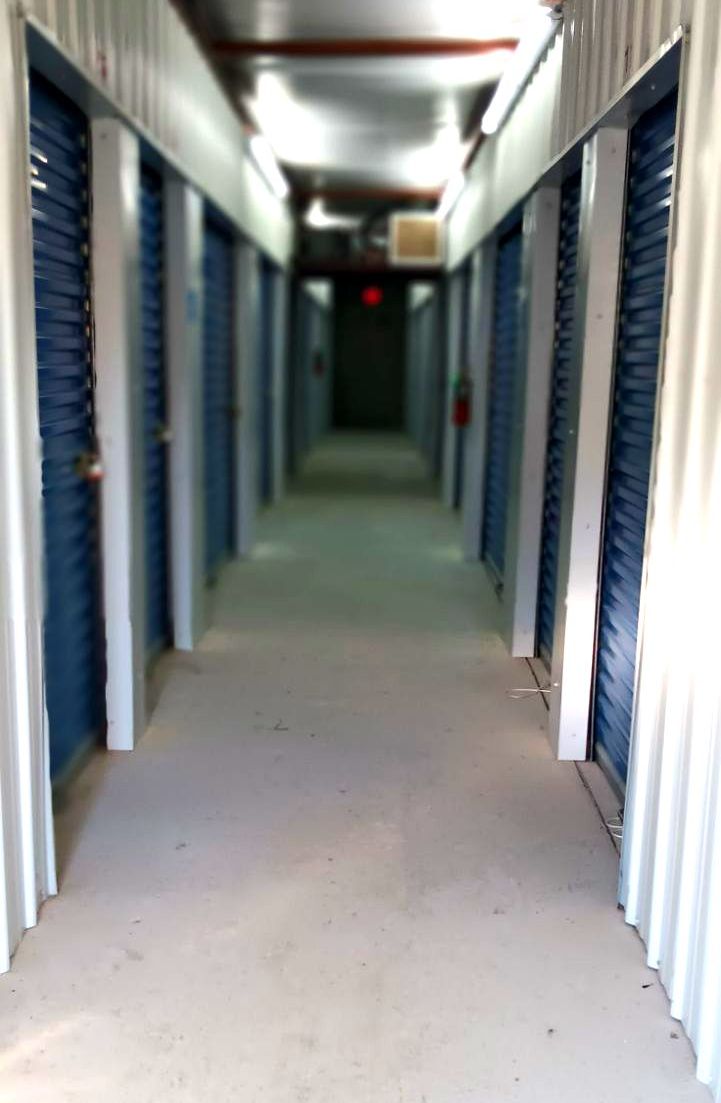 Woman and man with big cardboard boxes — Denham Springs, LA — Walker South Storage