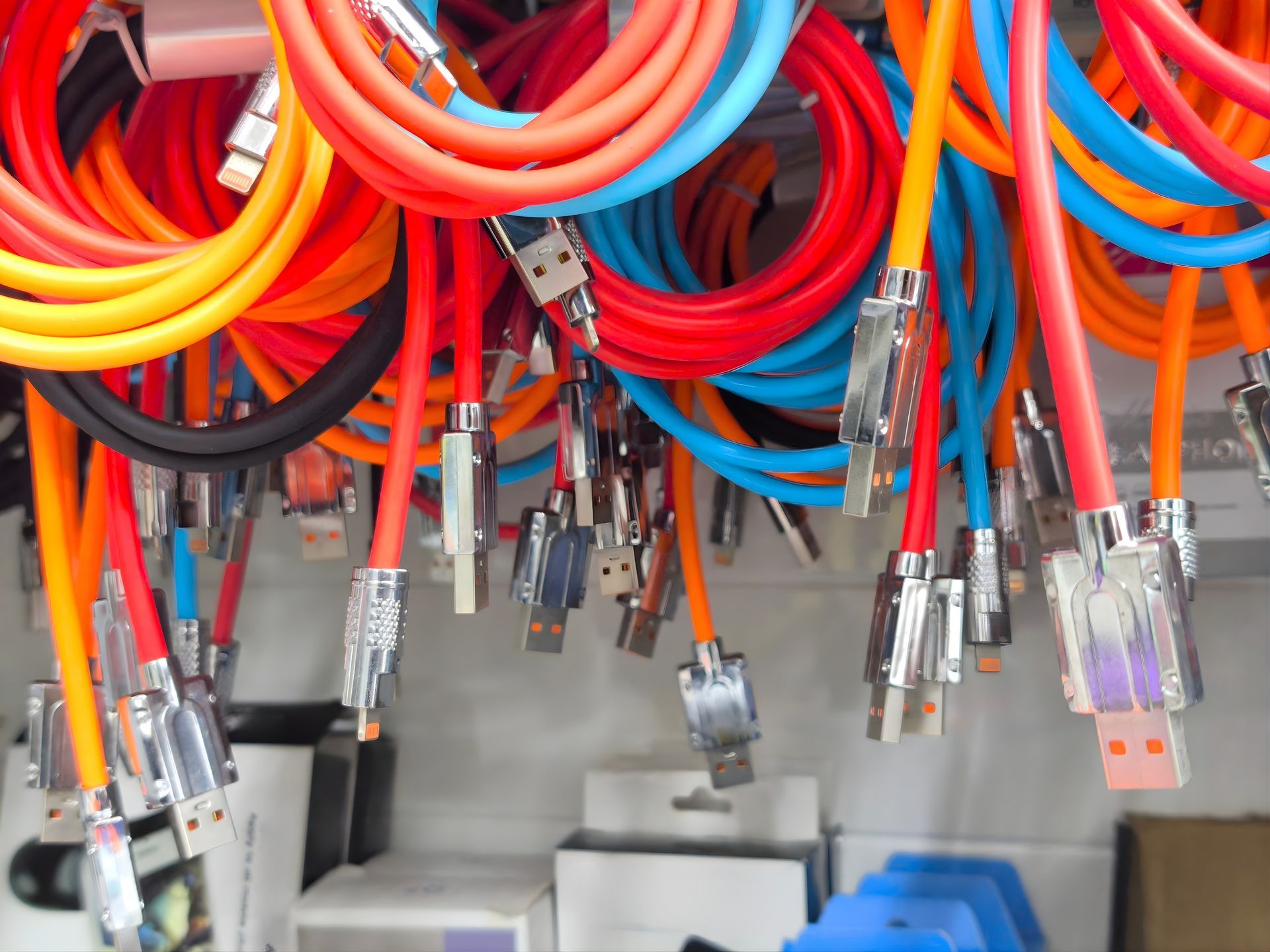 Colourful Charging Cables Hanging From a Display — Central Western Communications in Emerald, QLD