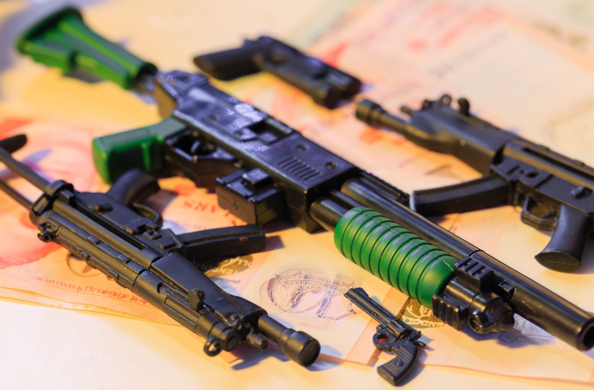 Toy Guns of Various Sizes and Styles on a Patterned Surface — Central Western Communications in Emerald, QLD