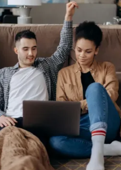 Couple on couch researching online therapy in Chesapeake, VA