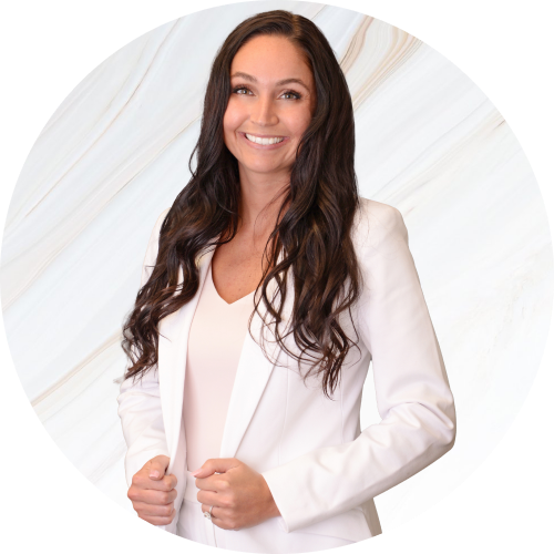 A woman with long hair is wearing a white jacket and smiling.