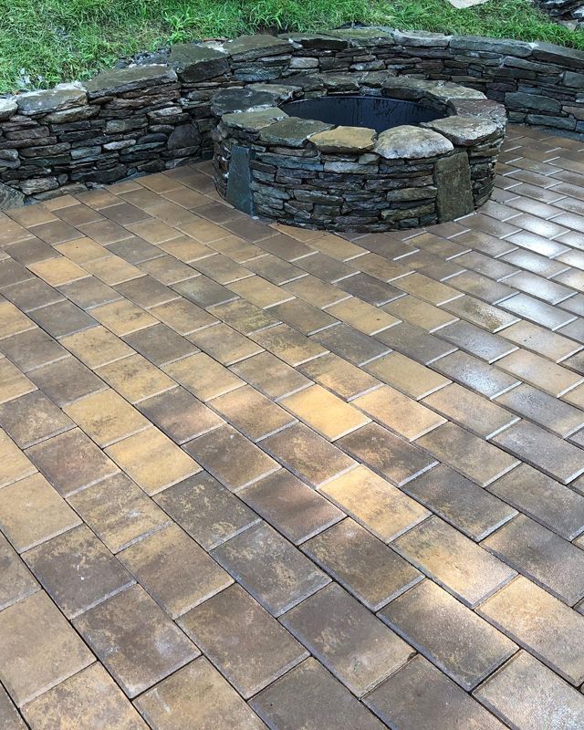 There is a fire pit in the middle of the patio.