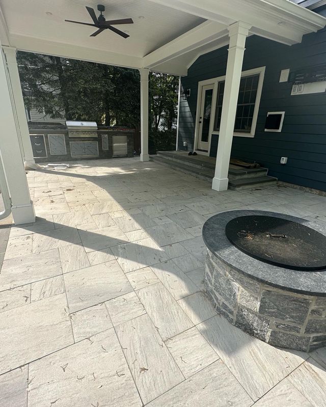 There is a fire pit in the middle of the patio.