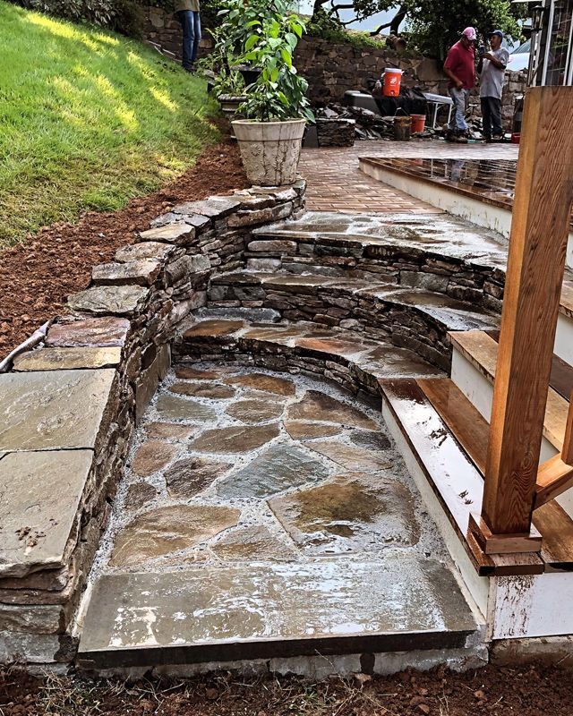 A stone walkway with stairs and a stone wall