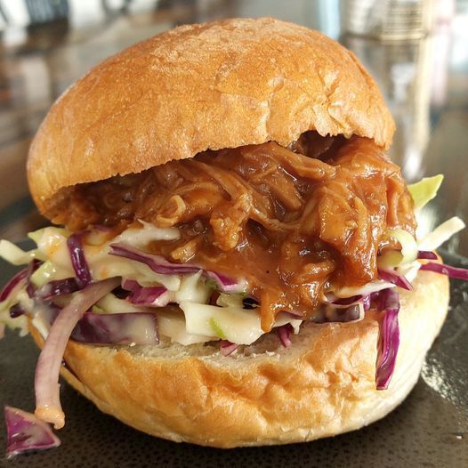 A Pulled Pork Sandwich With Coleslaw and Onions on a Bun — Coffee on High in Wauchope, NSW