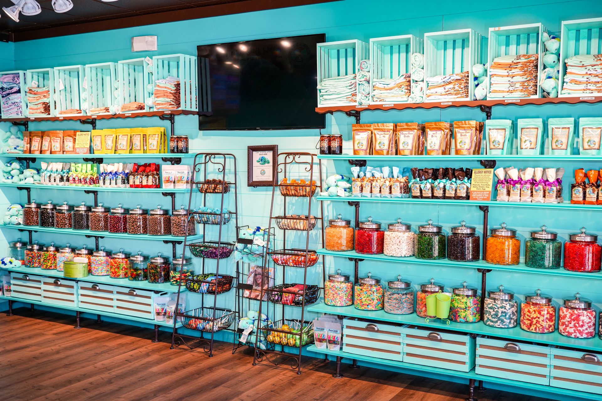 A candy store with lots of jars and shelves filled with candy.