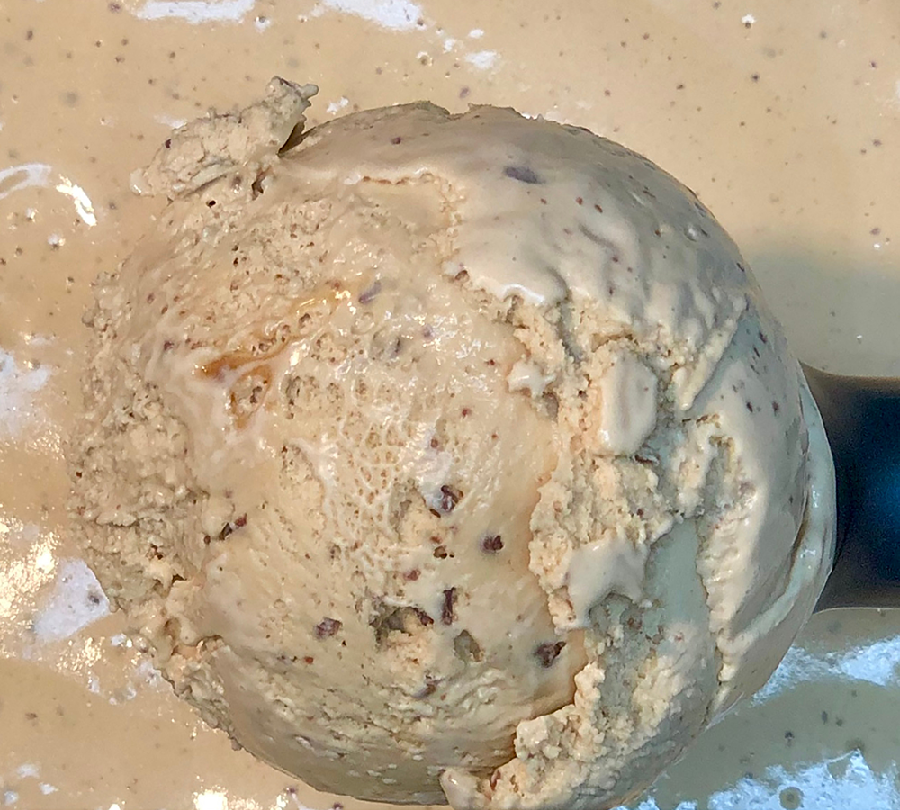 A close up of a scoop of ice cream on a table
