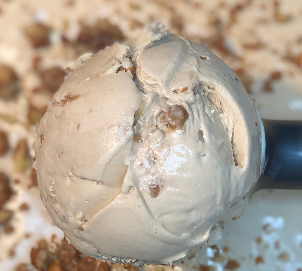 A close up of a scoop of ice cream on a table.