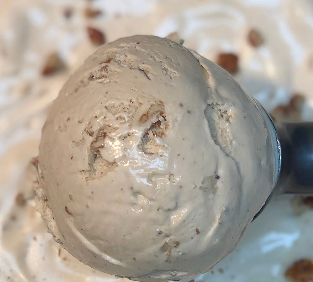 A close up of a scoop of ice cream on a plate