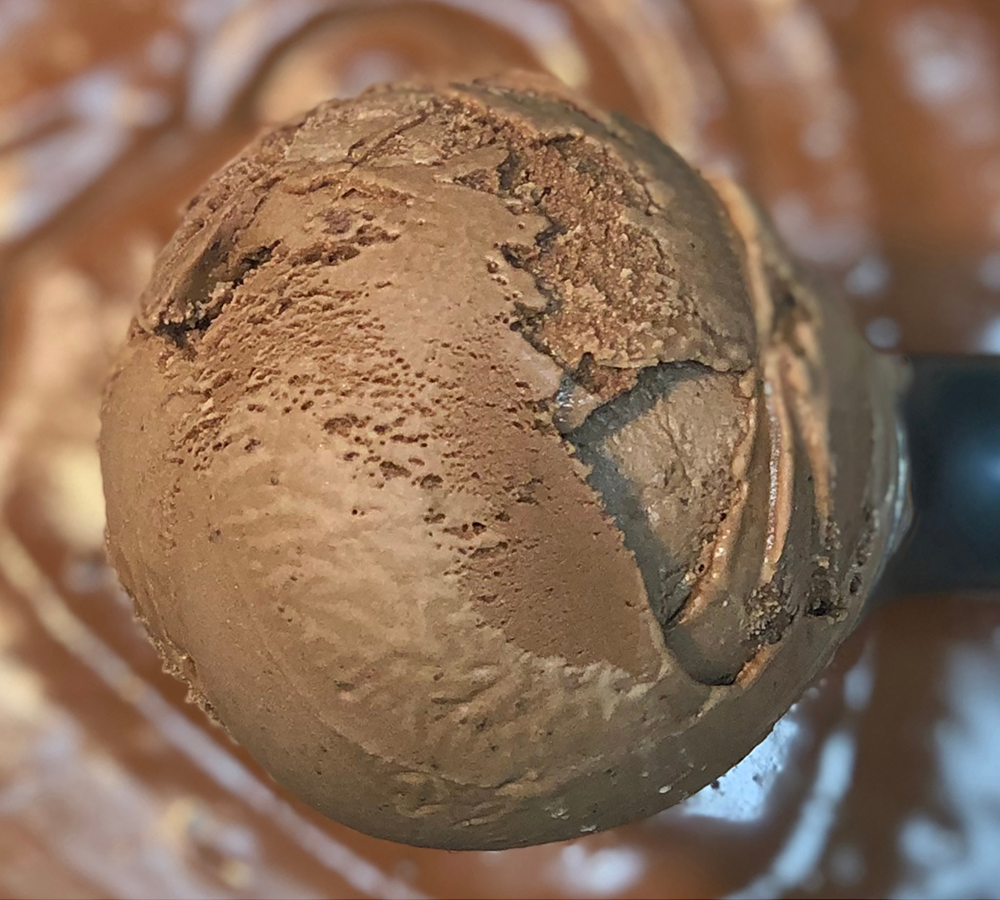 A close up of a scoop of chocolate ice cream