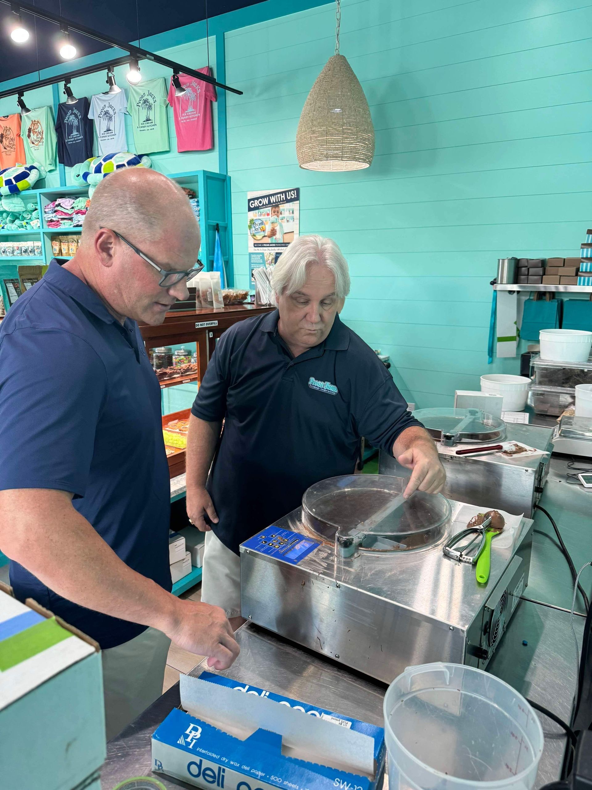 Two men are working on a machine in a restaurant.