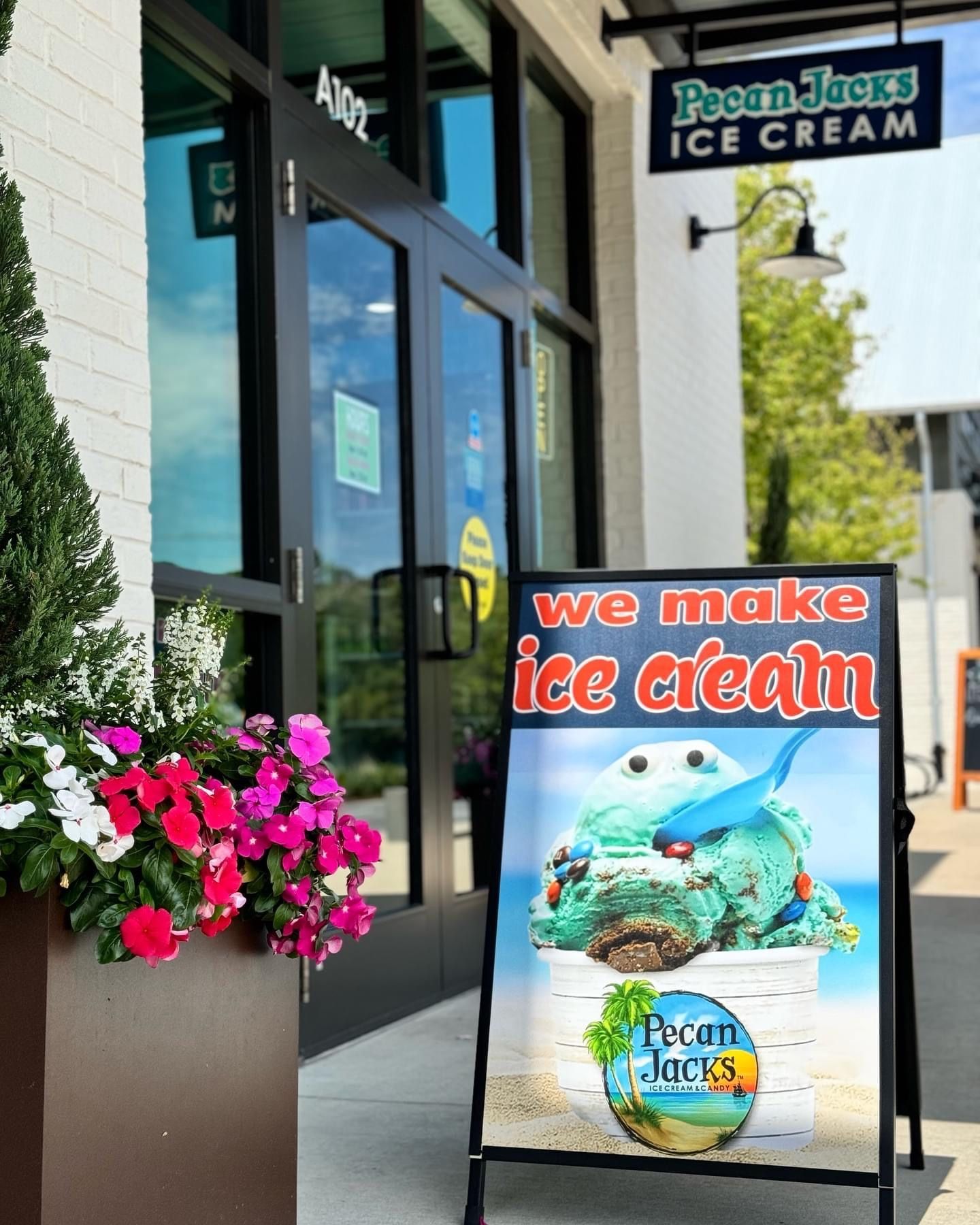A sign for pecan jacks ice cream says we make ice cream