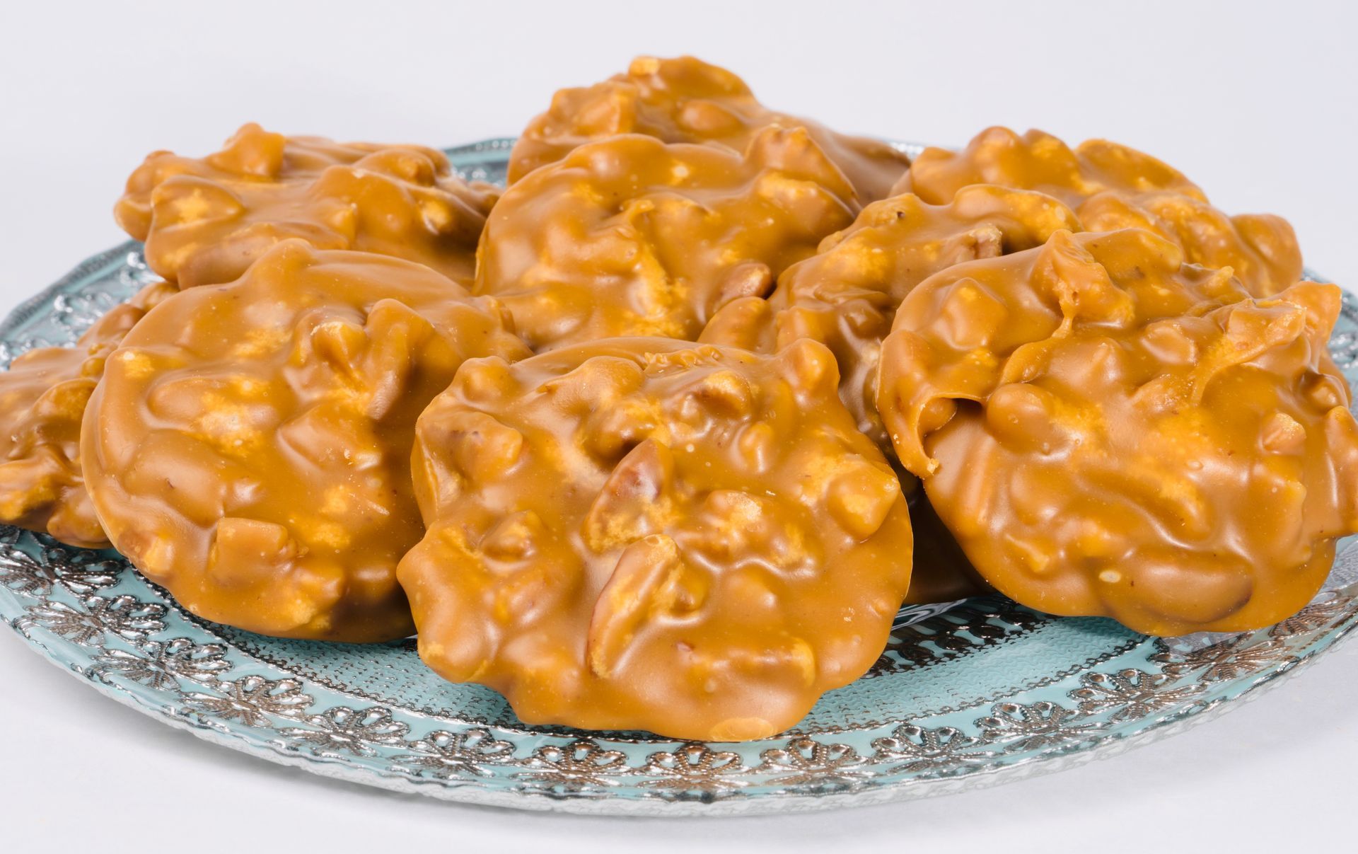 A close up of a plate of peanut butter pretzels on a table.