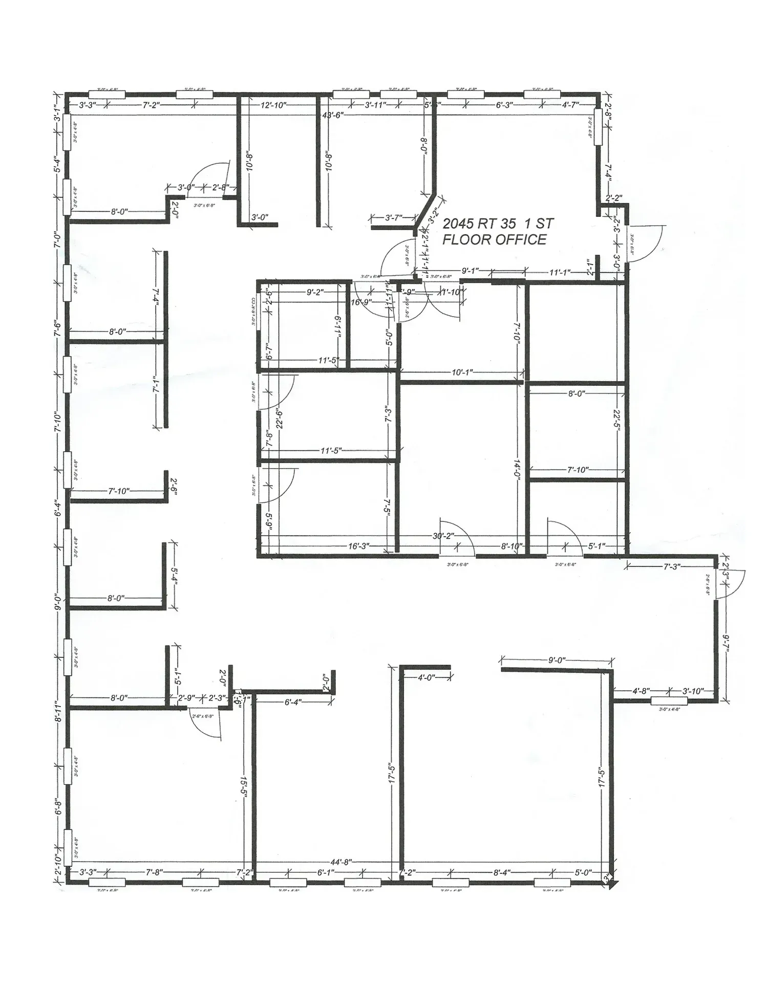 Architectural floor plan of an office building with several rooms and dimensions labeled.