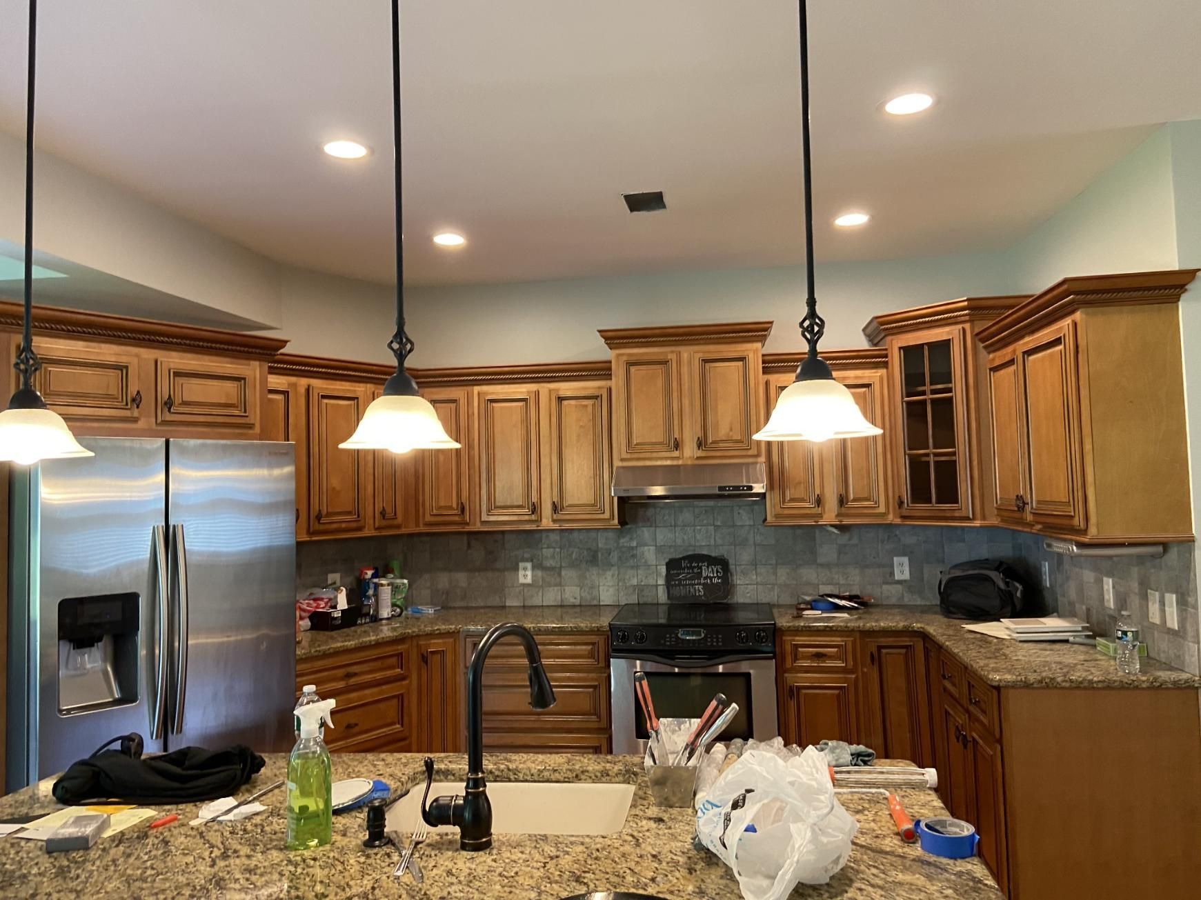 Kitchen with light brown cabinets, stainless steel appliances, and granite countertops.