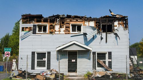 A white house that has been damaged by a fire.