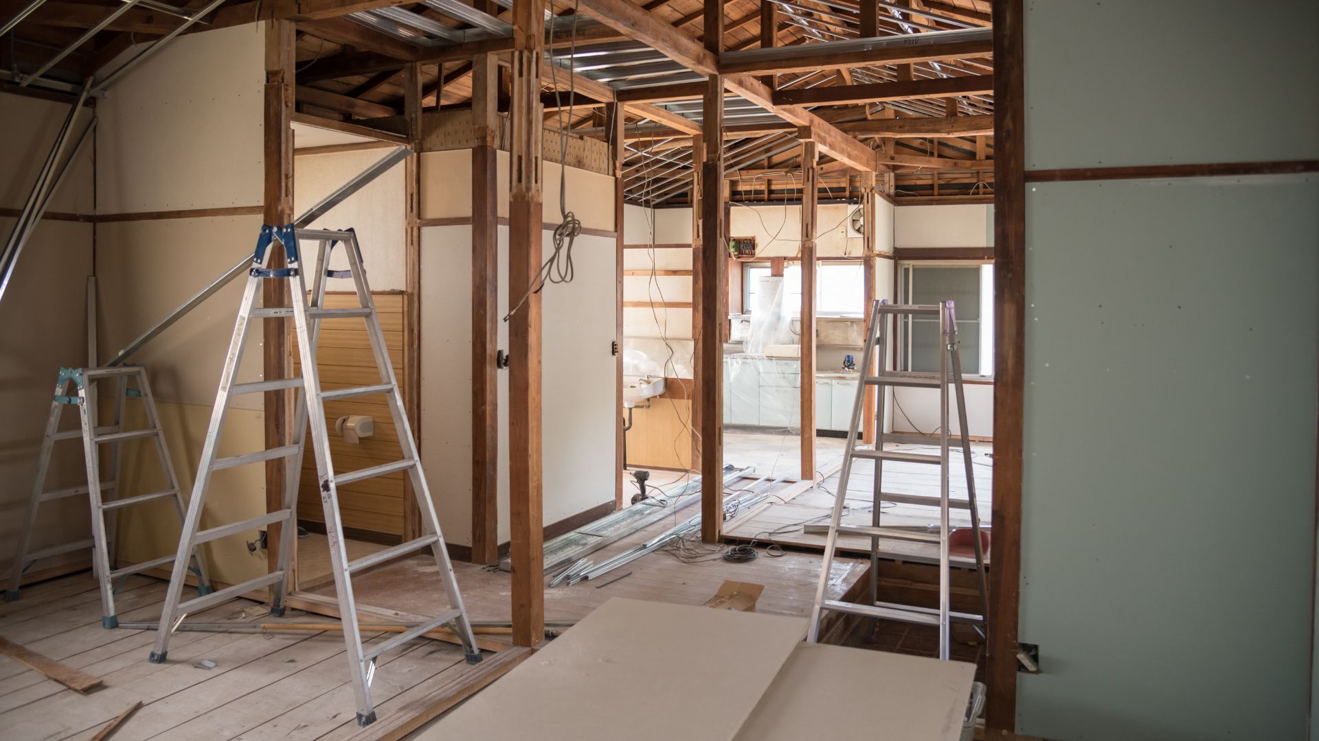 A room is being remodeled with ladders and scaffolding.