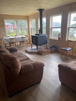 There is a wood stove in the middle of the living room.