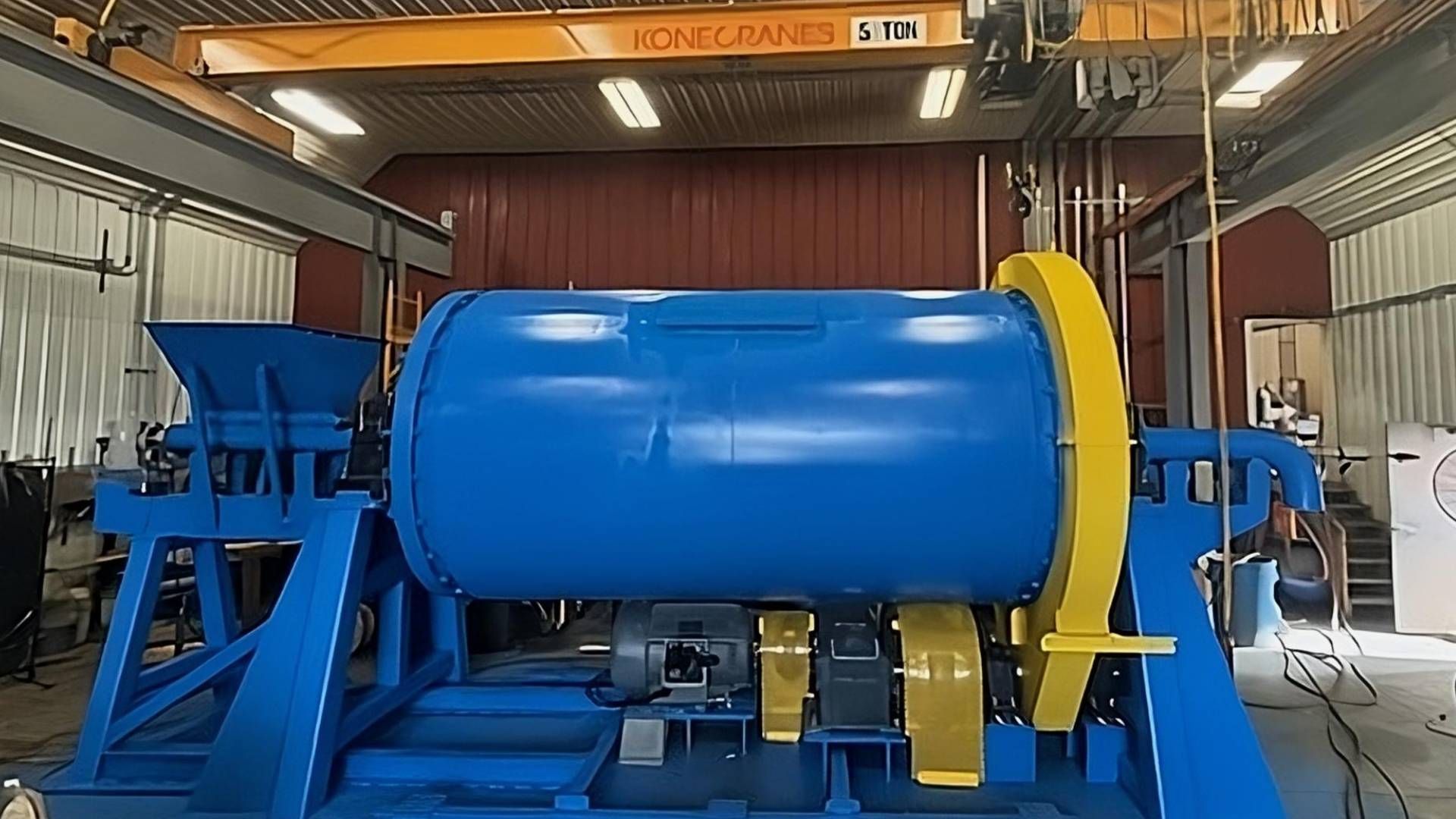 A blue and yellow custom ball mill in the middle of the workshop at Economy Ball Mill near Tollesbor