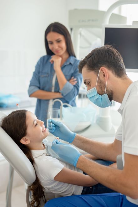 Dentist checking child's teeth